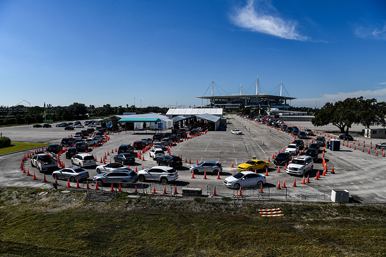 People wait inside vehicles at a drive-through COVID-19 testing site at Hard Rock Stadium in Miami, Florida on December 10, 2020. 