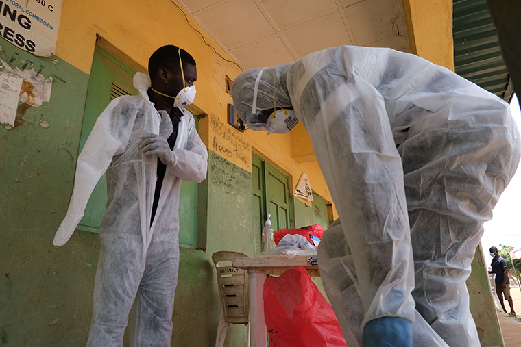 Health workers get dressed in protective gear as they prepare to takes samples during a community COVID-19 coronavirus testing campaign in Abuja, Nigeria on April 15. 