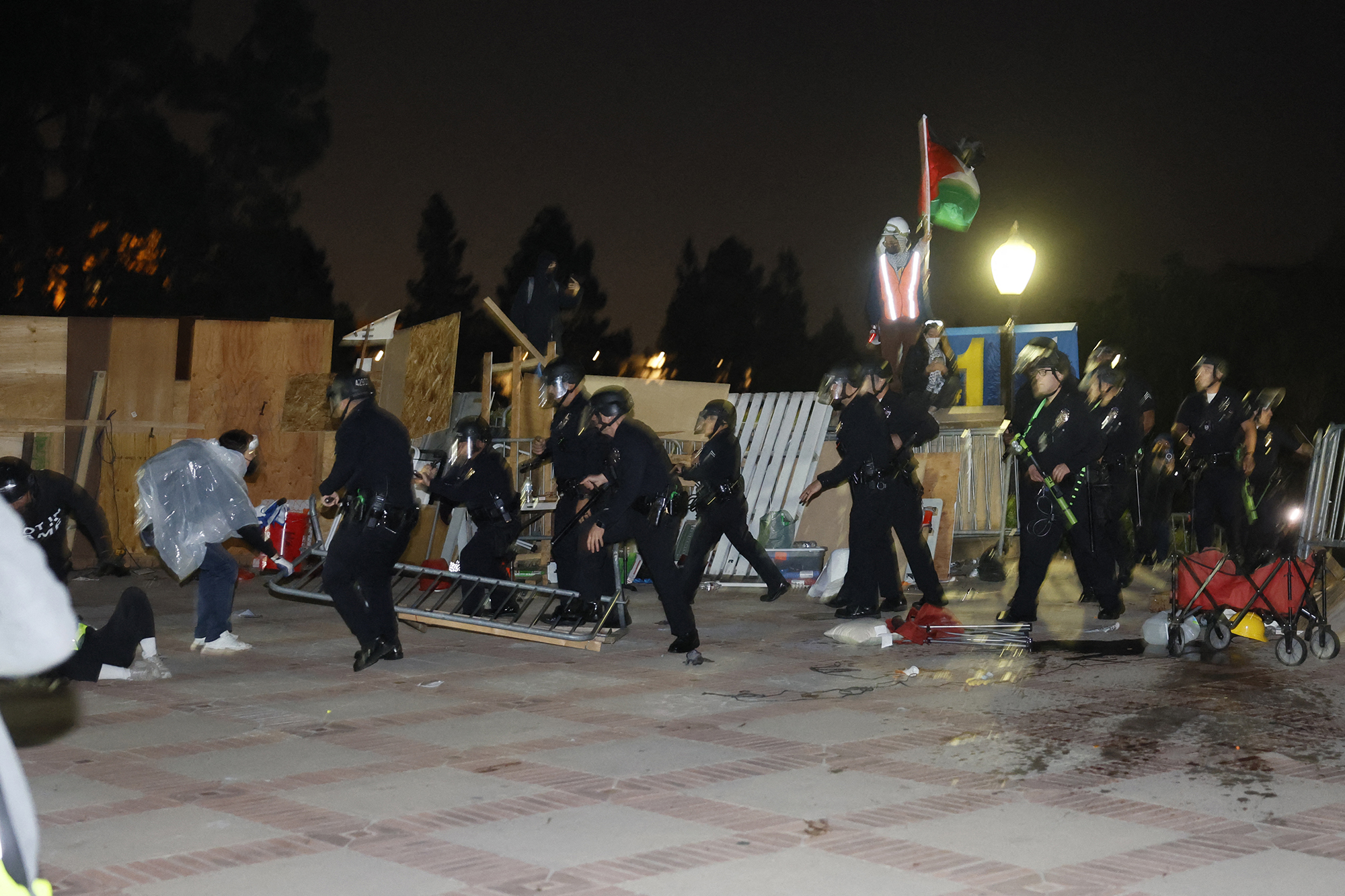Police breach the encampment of Pro-Palestinian students demonstrating on the campus of UCLA in Los Angeles, California, early on May 2.