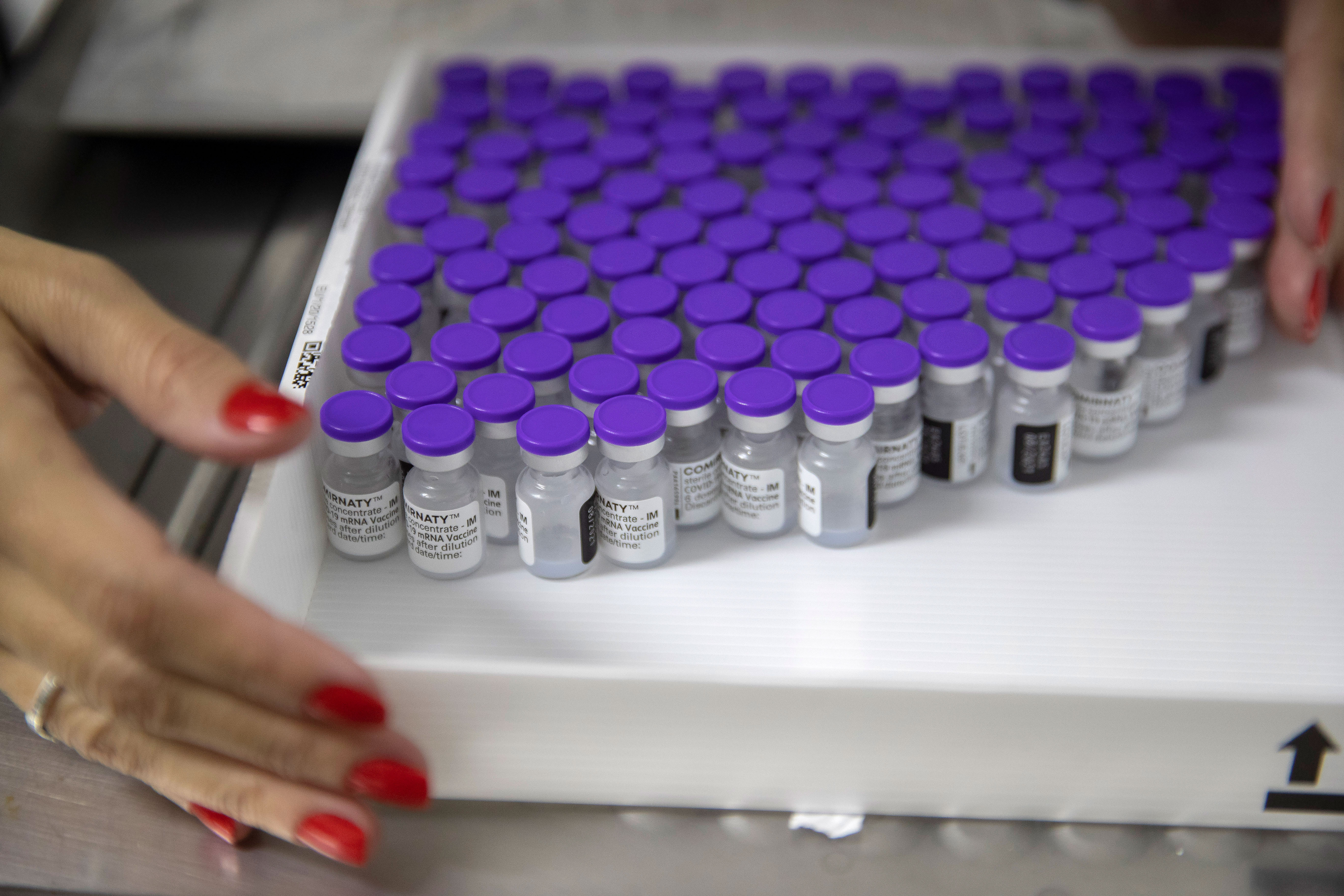 A health worker holds a tray with vials of the Pfizer Covid-19 vaccine in São Paulo, Brazil, on May 6.