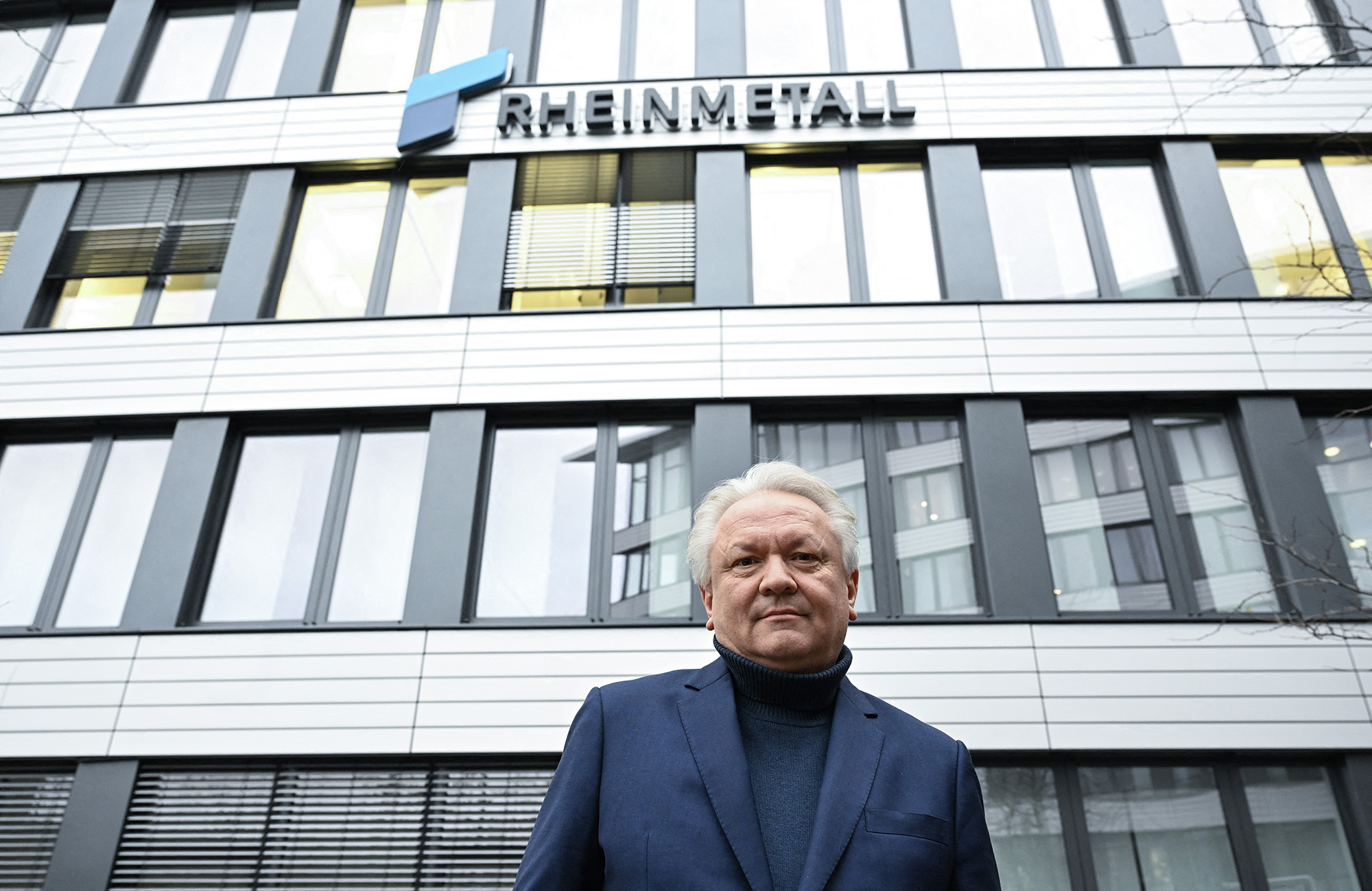 Armin Papperger, CEO of German defense and automotive group Rheinmetall AG poses in front of the company's logo and headquarters in Duesseldorf, Germany, on January.