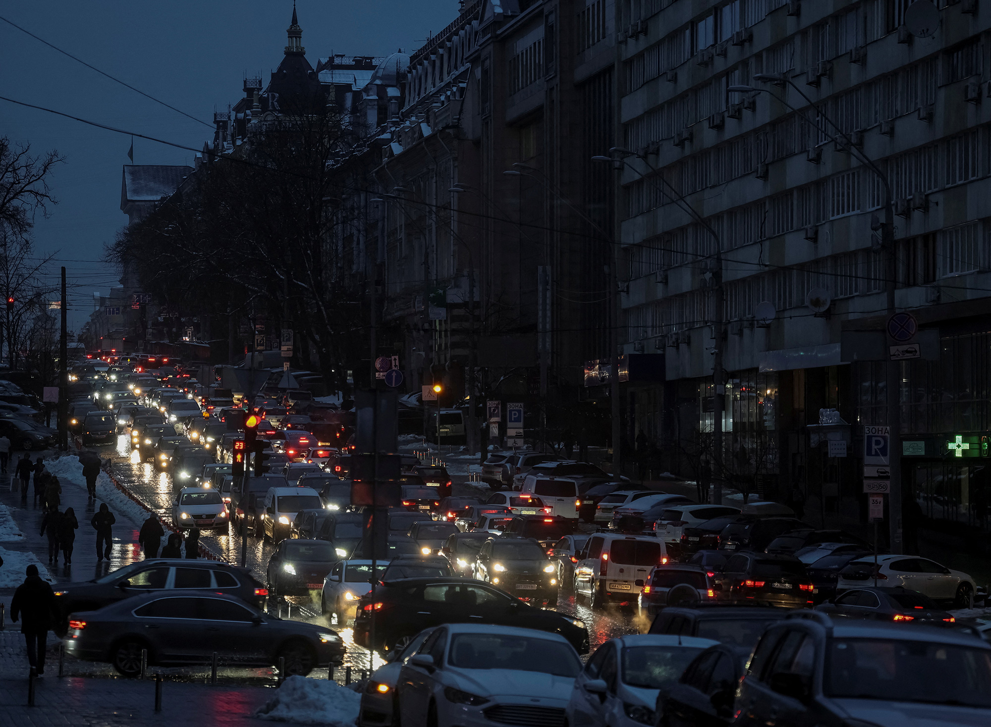 Cars lined up on a street during a blackout after critical civil infrastructure was hit by Russian missile attacks in Kyiv on December 16.