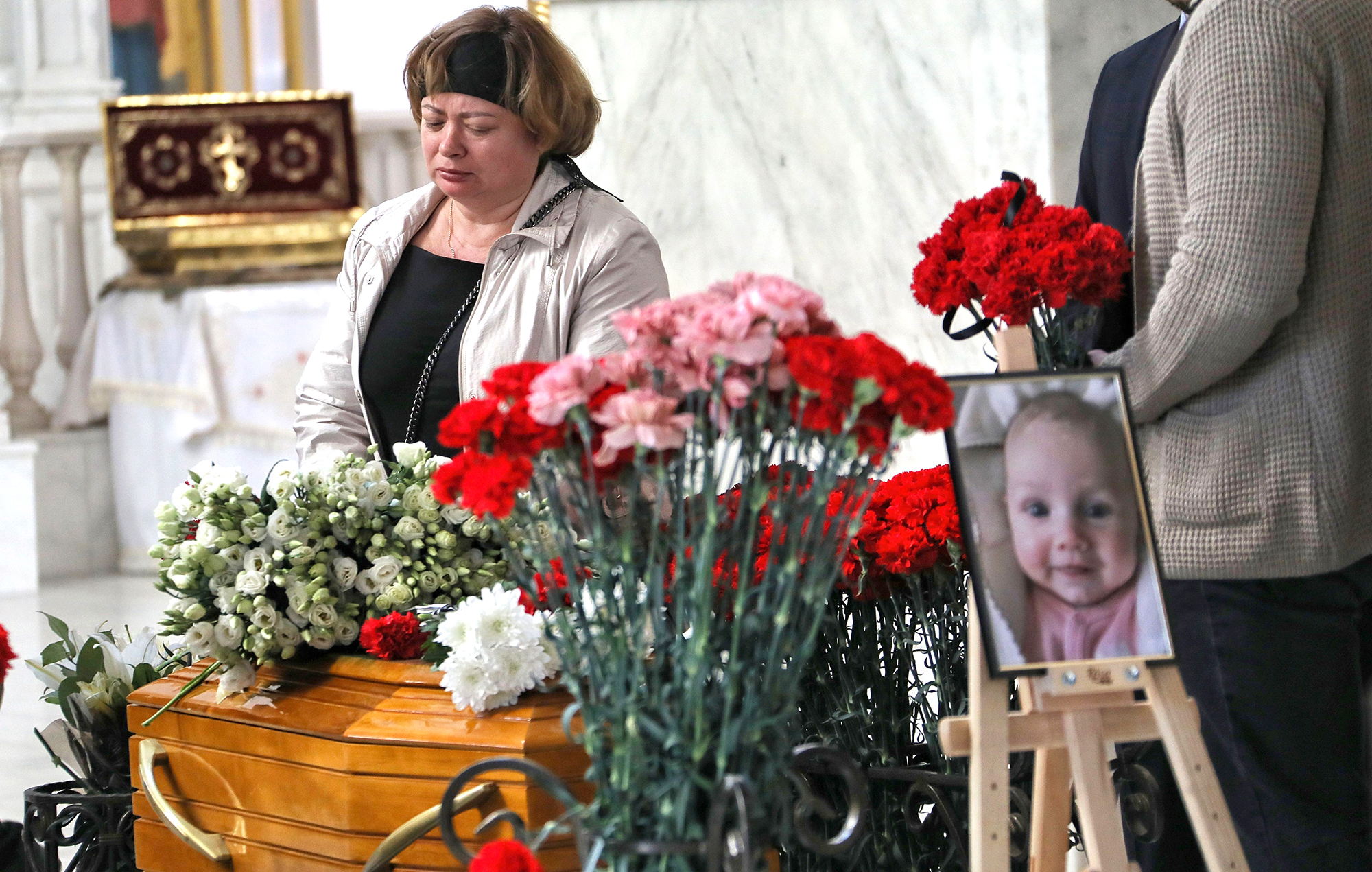 ODESA, UKRAINE - APRIL 27, 2022 - Relatives and friends attend the funeral service of Valeriia Hlodan, her three-month-old baby girl Kira and her mother Liudmyla Yavkina at Transfiguration Cathedral, Odesa, Ukraine, on April 27.