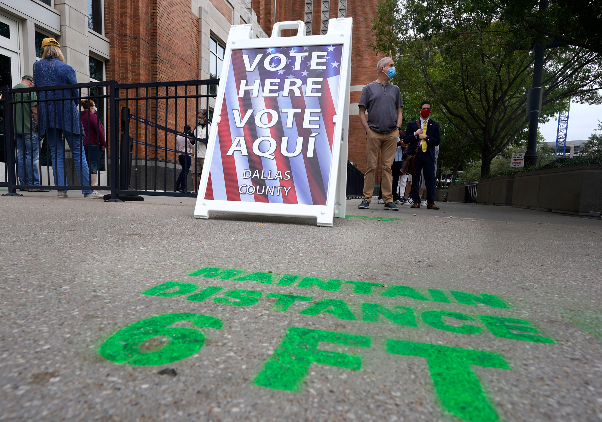 Voters line up and wait to cast a ballot for the general election at the American Airlines Center during early voting on October 15 in Dallas. 