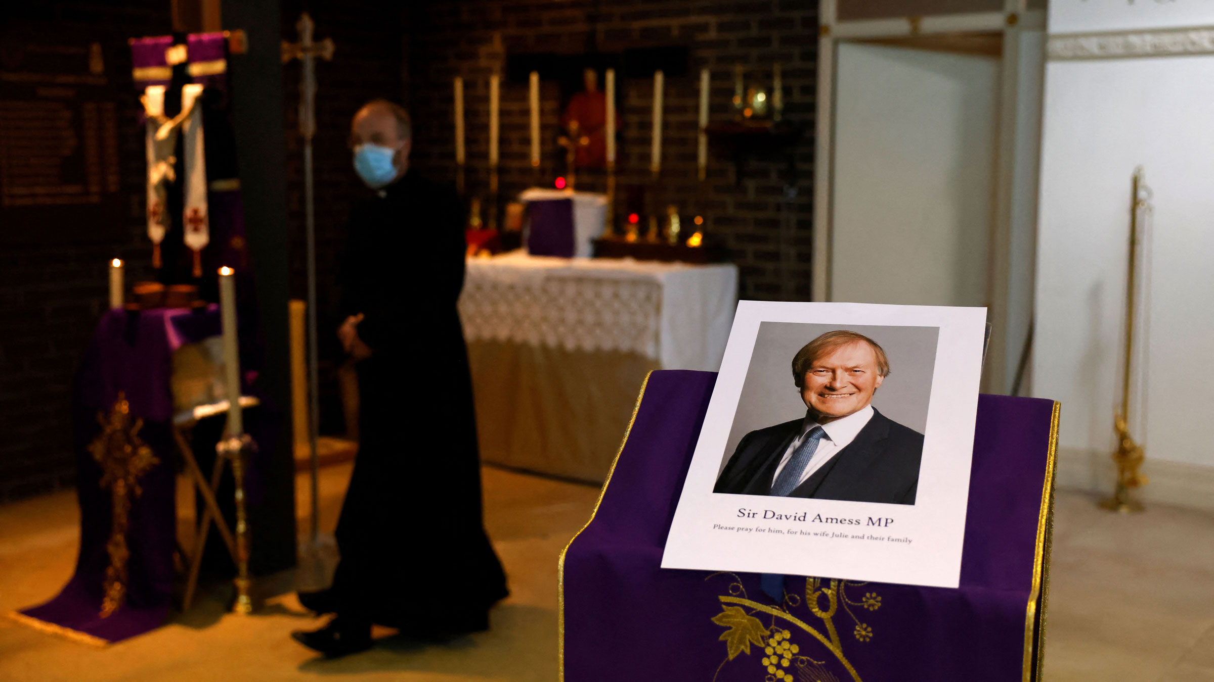 A photo of David Amess is seen before a service Friday at Saint Peter's Catholic Parish of Eastwood.