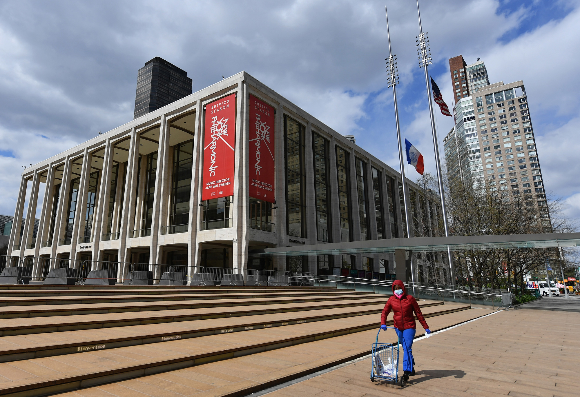 A woman pushes a cart outside Lincoln Center and the New York Philharmonic on April 16 in New York City. 