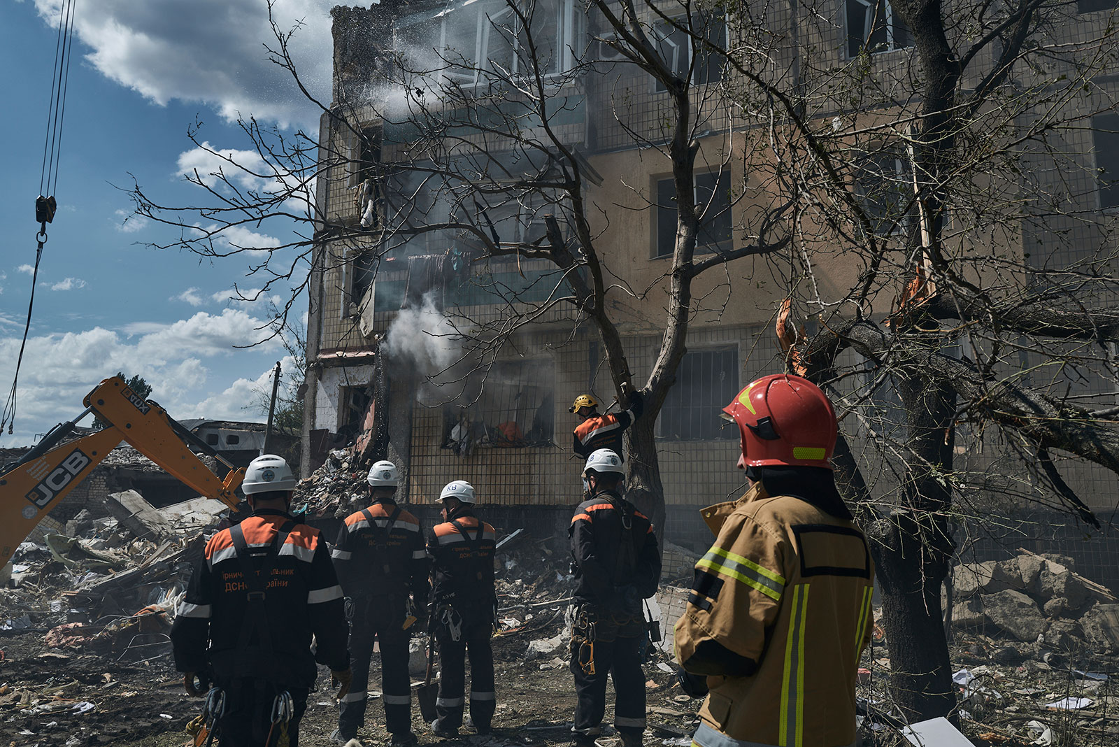 Emergency personnel work at the scene after a missile hit an apartment building in Kryvyi Rih, Ukraine, on Monday, July 31.
