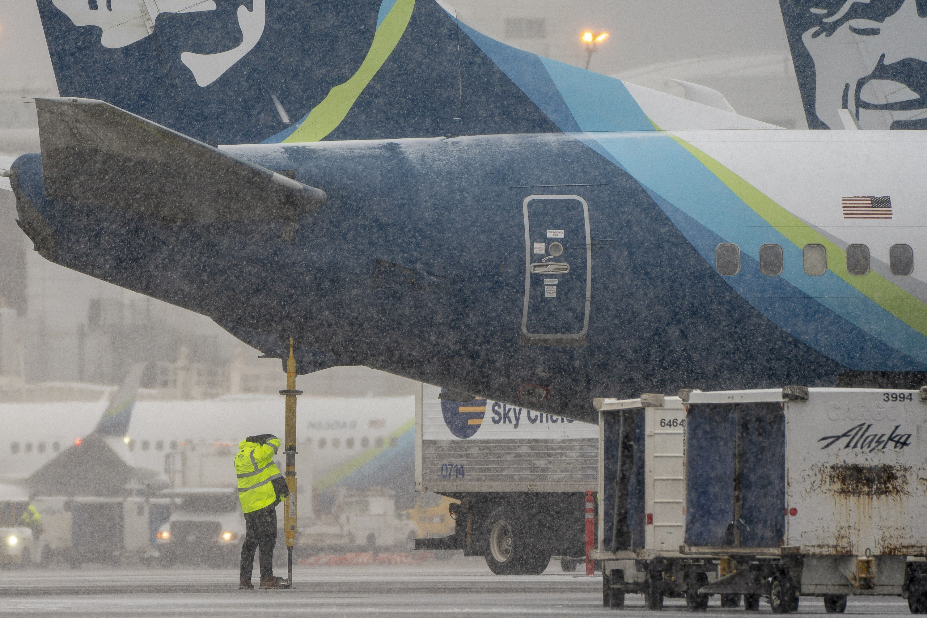 A worker below an Alaska Airlines plane at Seattle-Tacoma International Airport in Seattle, Washington on Tuesday.