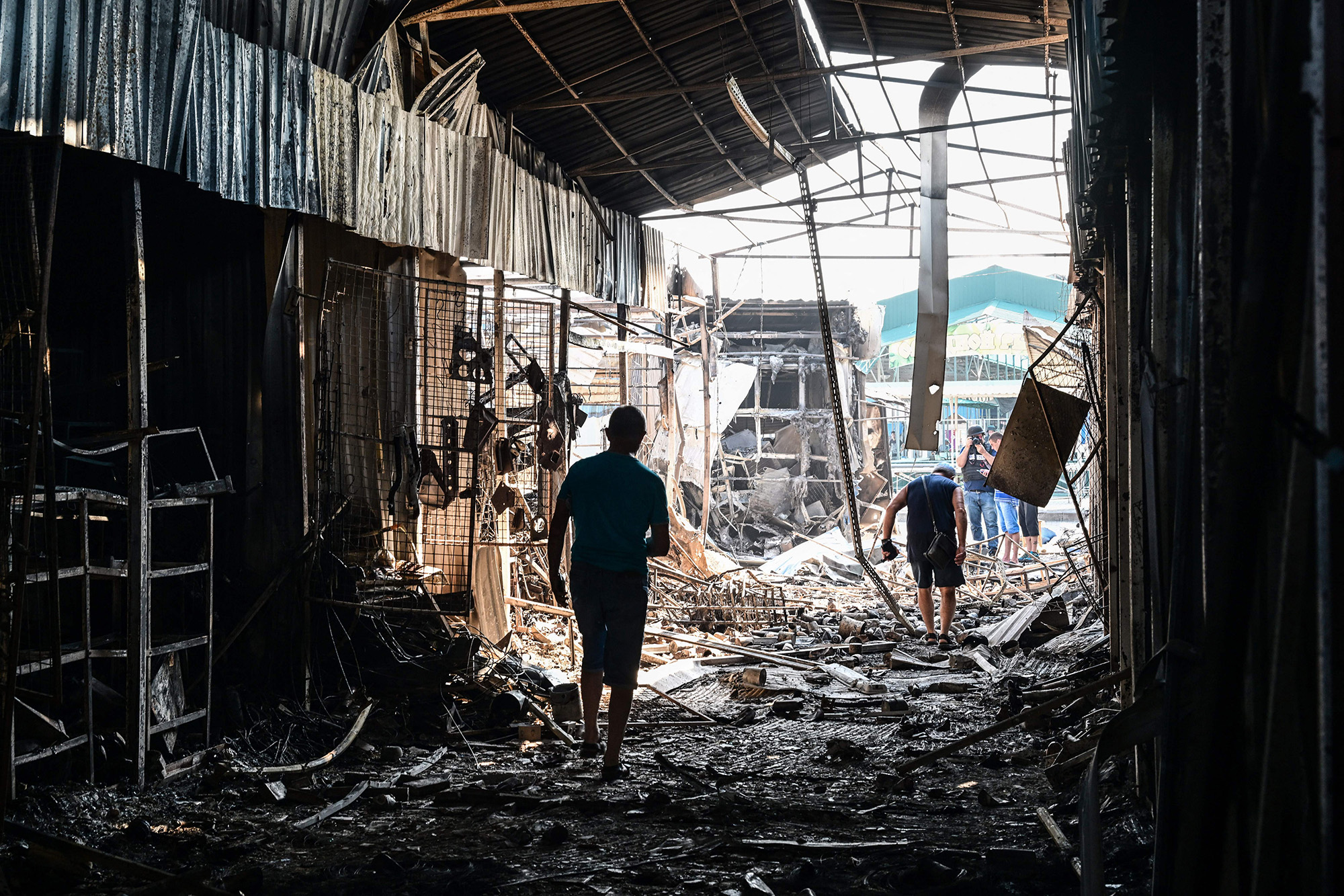 People walk through the damage caused to the central market in Slovyansk, Ukraine, on July 6.