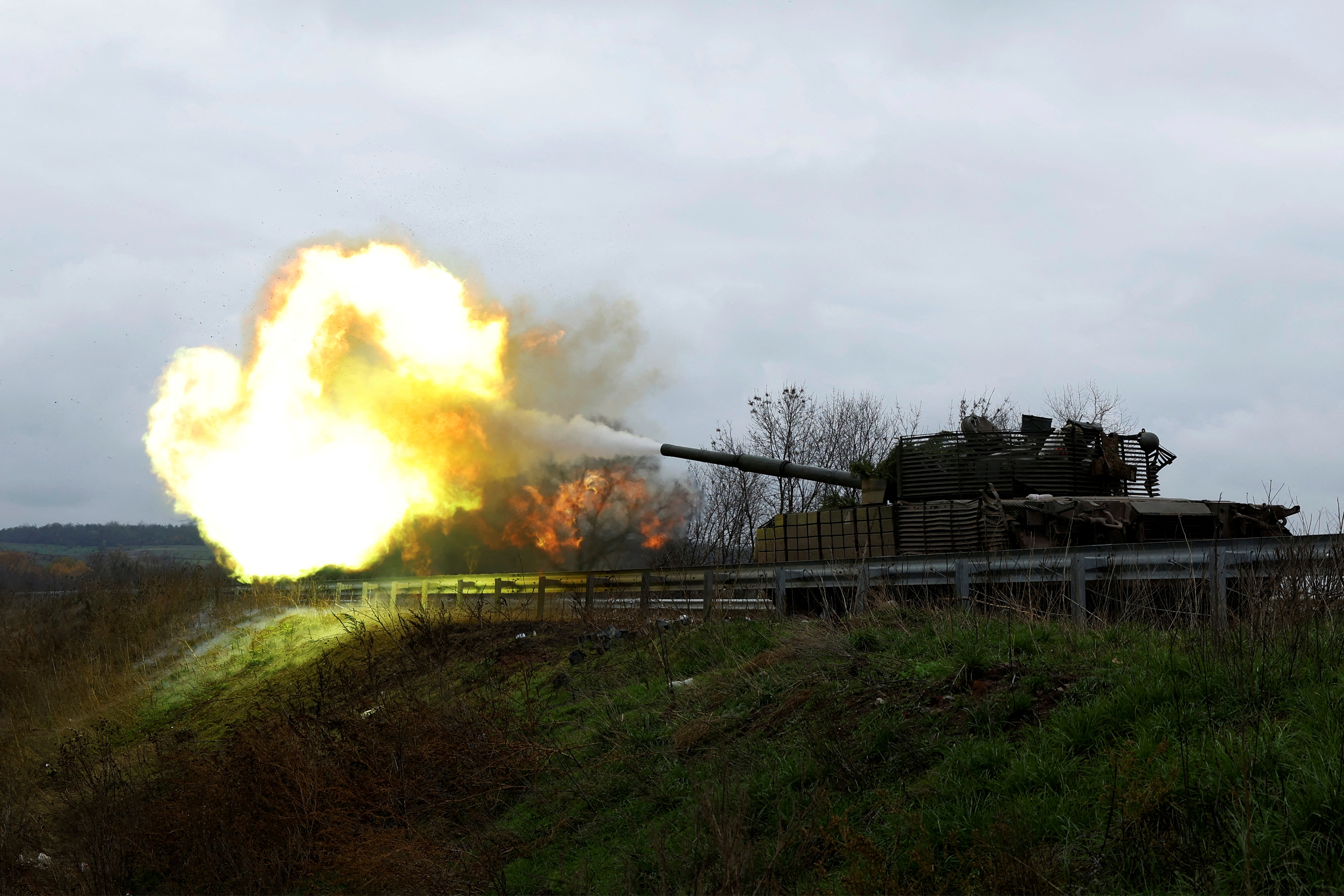 Ukrainian soldiers fire a round from a tank on the frontline in eastern Donbas region of Bakhmut on Friday. The tank was captured during a battle against Russian forces in March.
