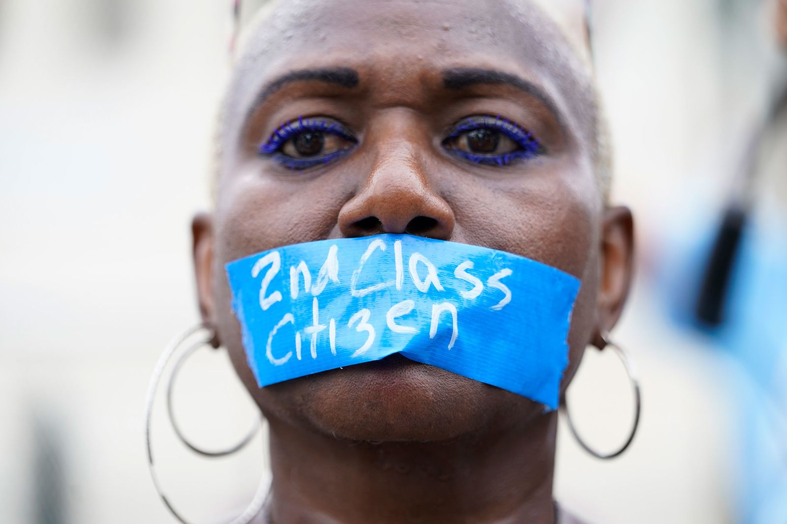 A pro-abortion rights activist wears tape across their mouth reading "2nd Class Citizen" in Washington, DC, on Friday. 
