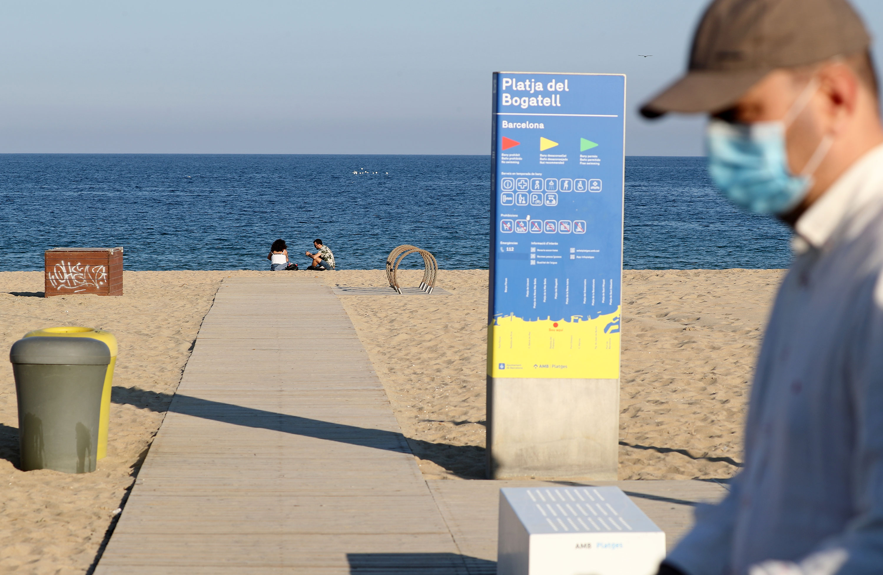 People relax on a beach in Barcelona on May 20.