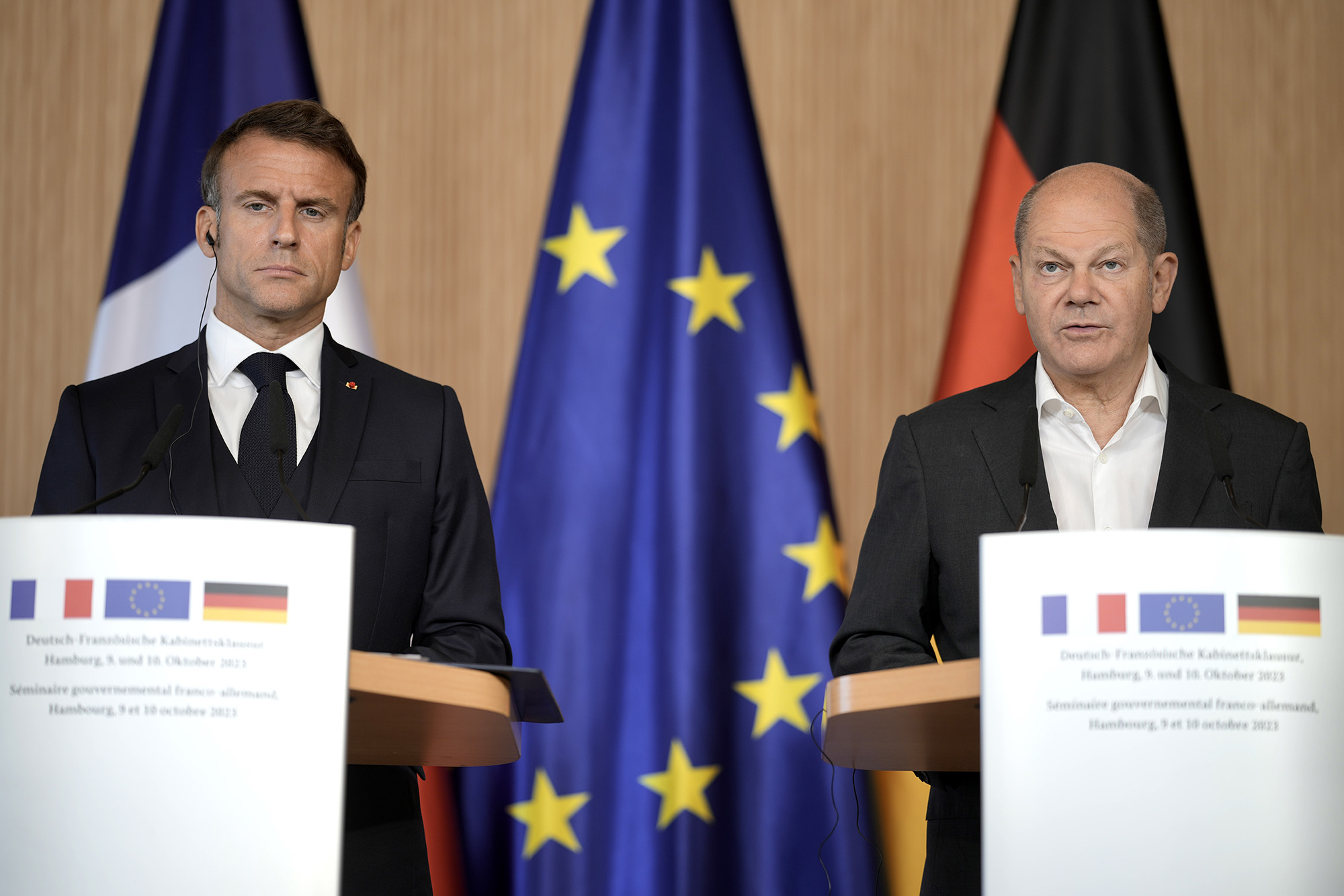 German Chancellor Olaf Scholz, right, and French President Emmanuel Macron speak at a news conference after a joint cabinet meeting of the German and French governments in Hamburg on Tuesday.