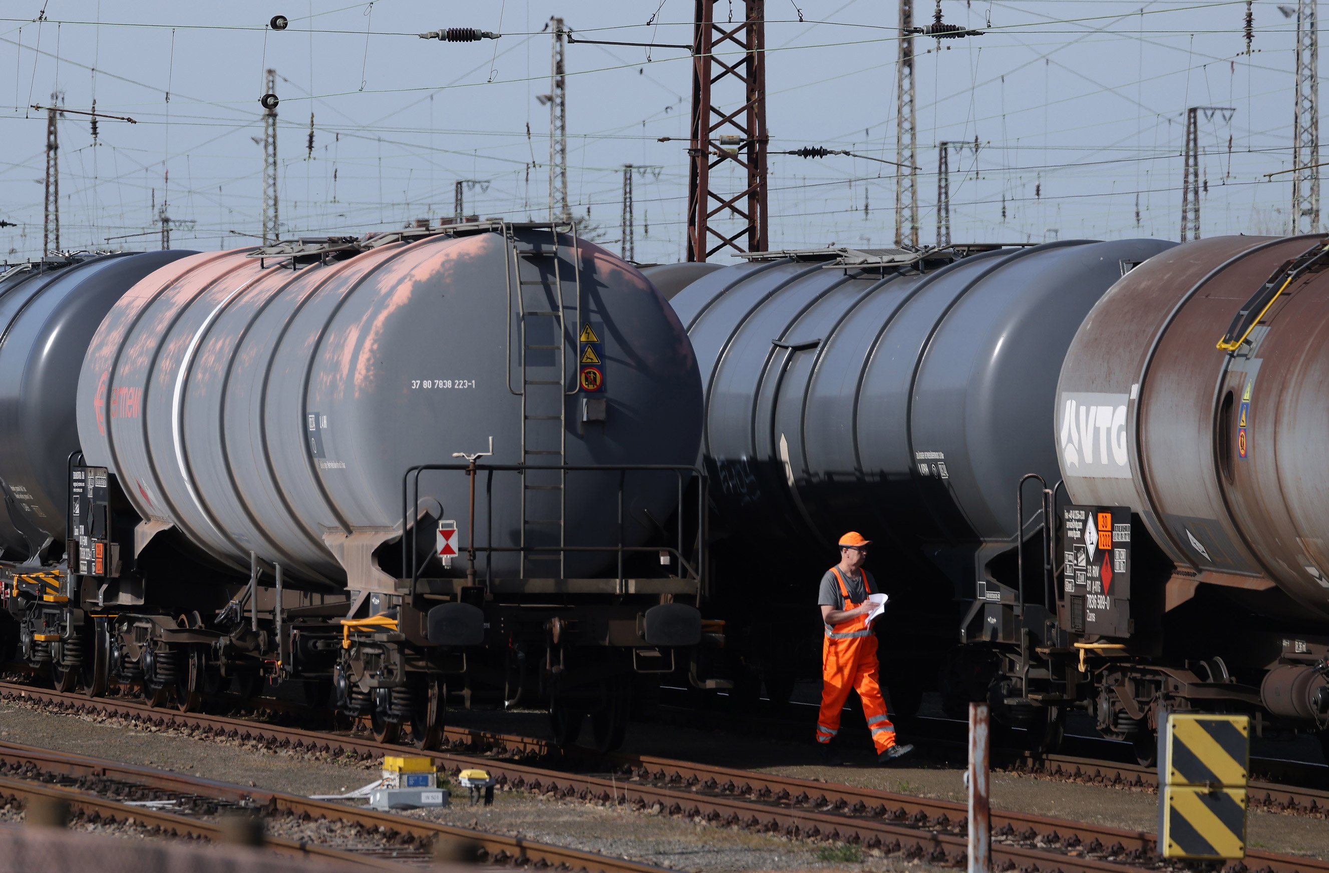 A railway worker walks among tank cars used carrying petroleum products refined from Russian oil, in Spergau, Germany, on April 12.