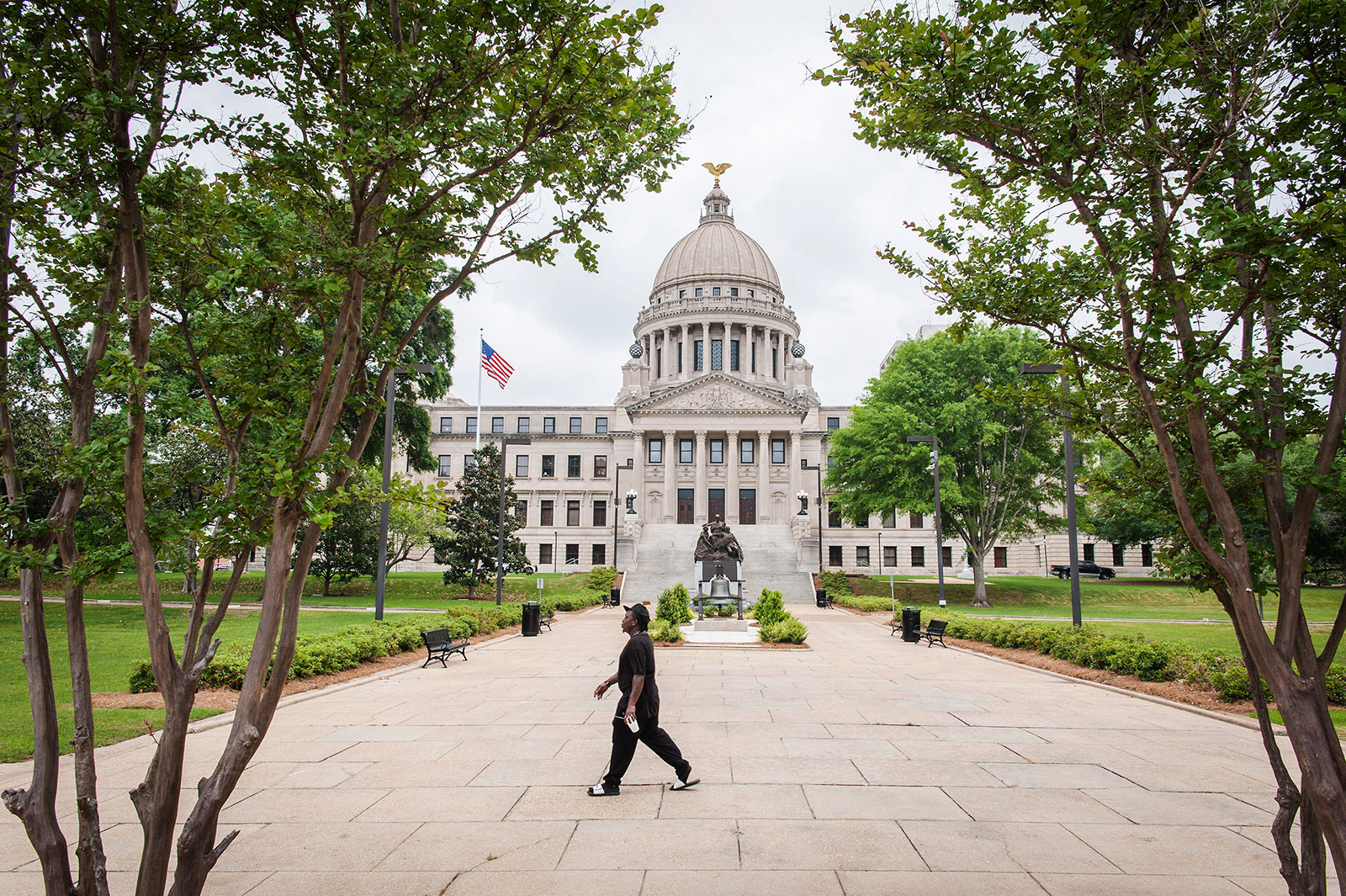 A person walks by the Mississippi State Capitol building in Jackson on Wednesday, April 8.