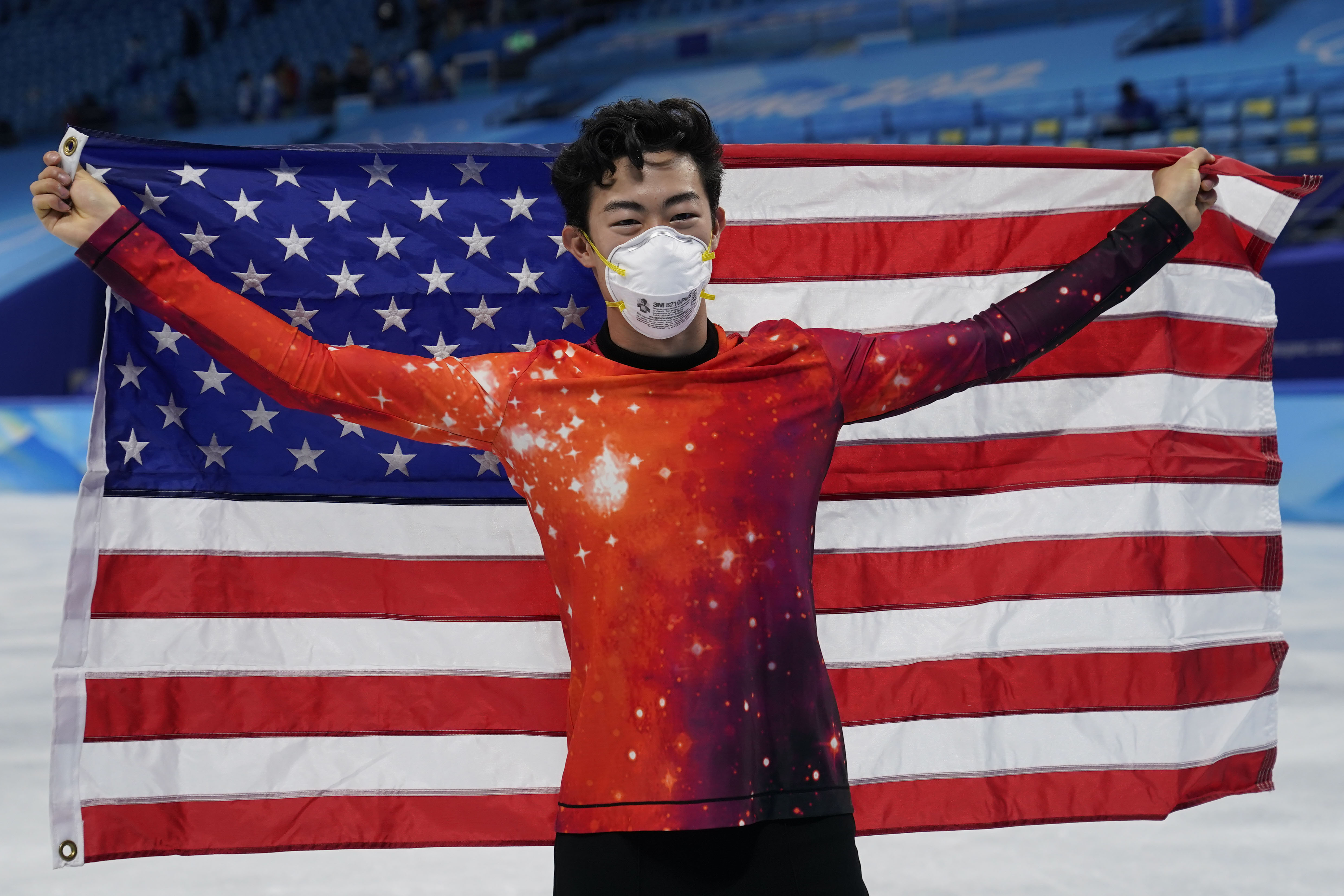 Nathan Chen celebrates winning the gold medal in men's singles figure skating on Thursday.