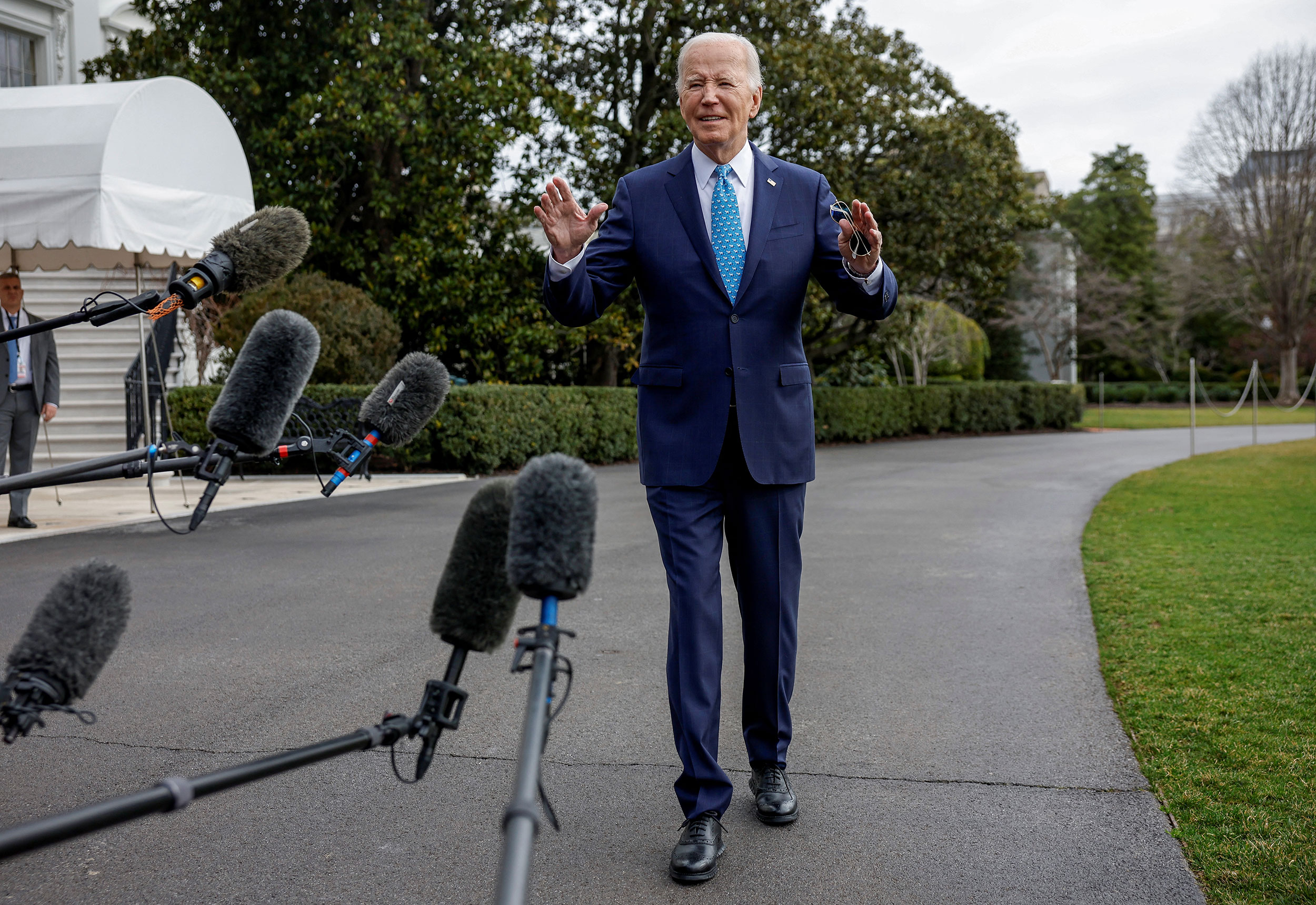 US President Joe Biden speaks to members of the media before departing from the White House in Washington, DC, on January 30.