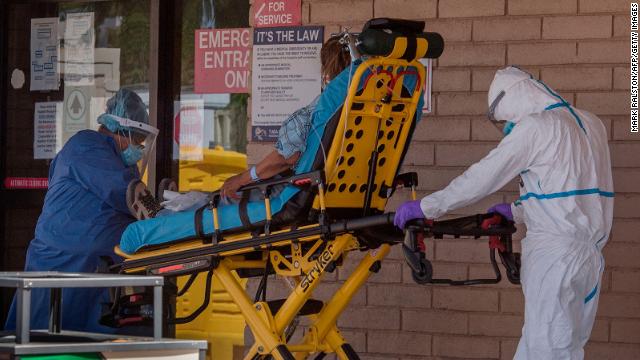 A patient is taken from an ambulance to the emergency room of a hospital in the Navajo Nation town of Tuba City in Arizona on May 24, 2020 