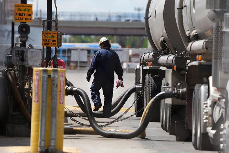 A driver unloads raw crude oil from his tanker on May 24 in Salt Lake City, Utah.