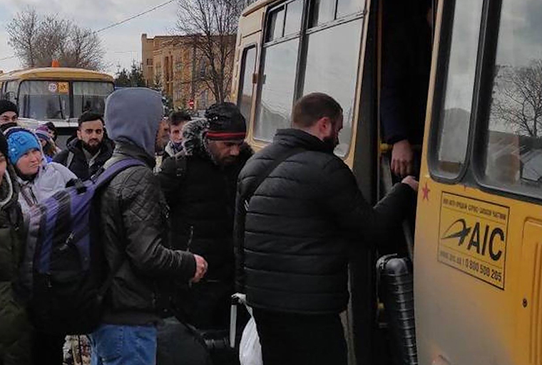 Civilians flee the city on March 8, in Sumy, Ukraine.