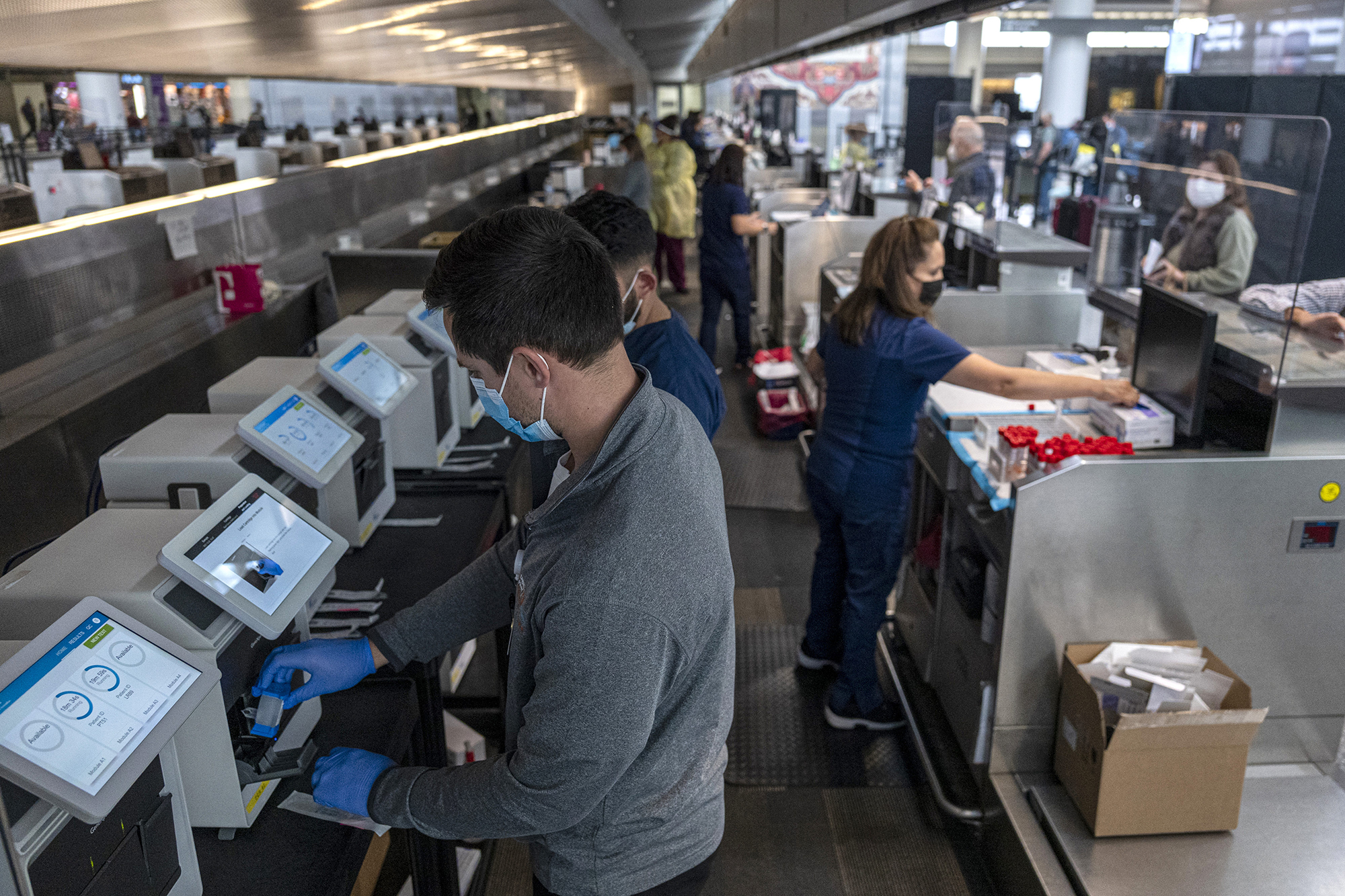 Medical workers at a Dignity Health-GoHealth Urgent Care Covid-19 testing site in the international terminal at San Francisco International Airport (SFO) in San Francisco, California, U.S., on Thursday, December 2nd, 2021. 