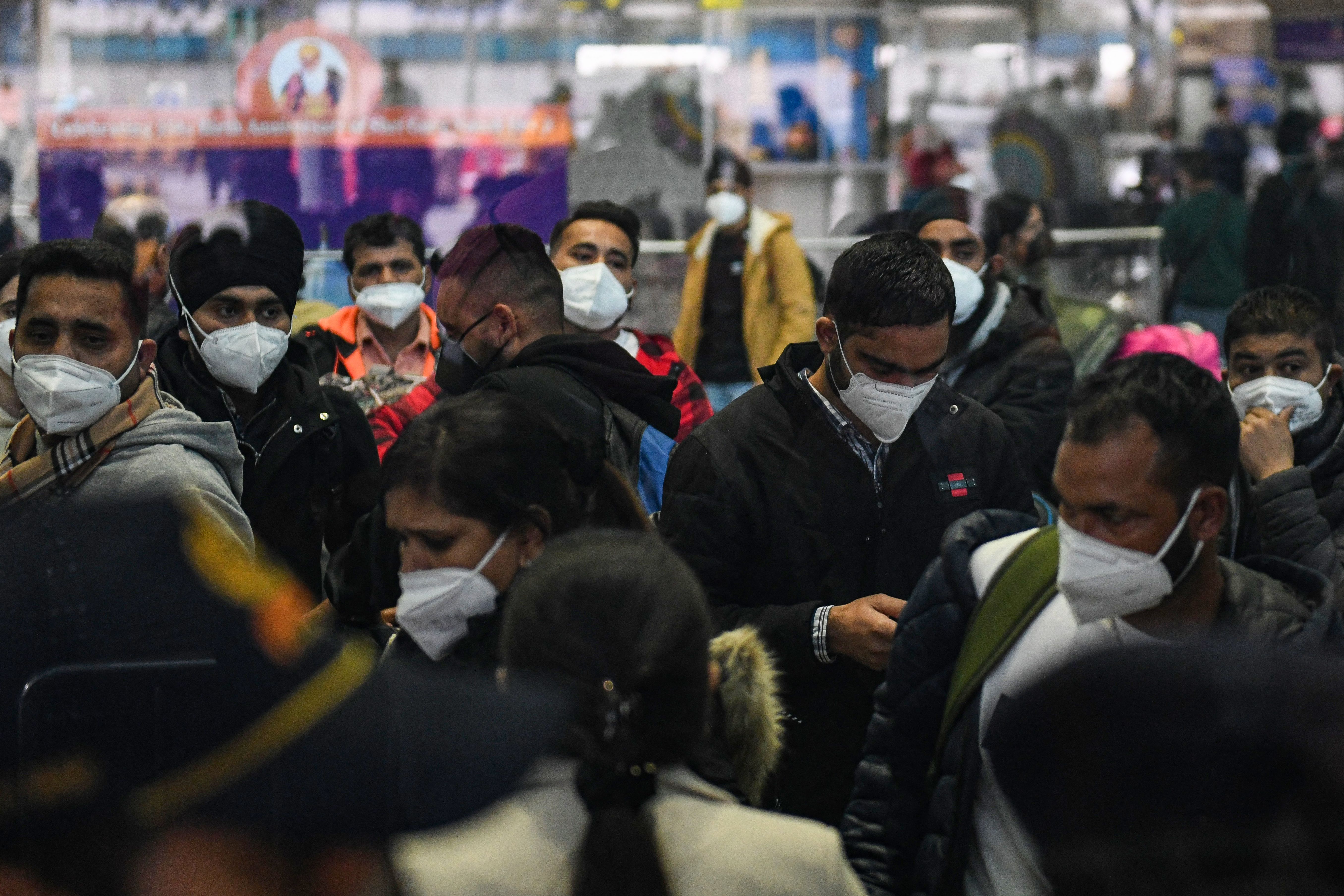 Passengers arriving from Italy wait to undergo a Covid-19 coronavirus screening at at Sri Guru Ram Dass Jee International Airport on the outskirts of Amritsar on January 6, 2022. 