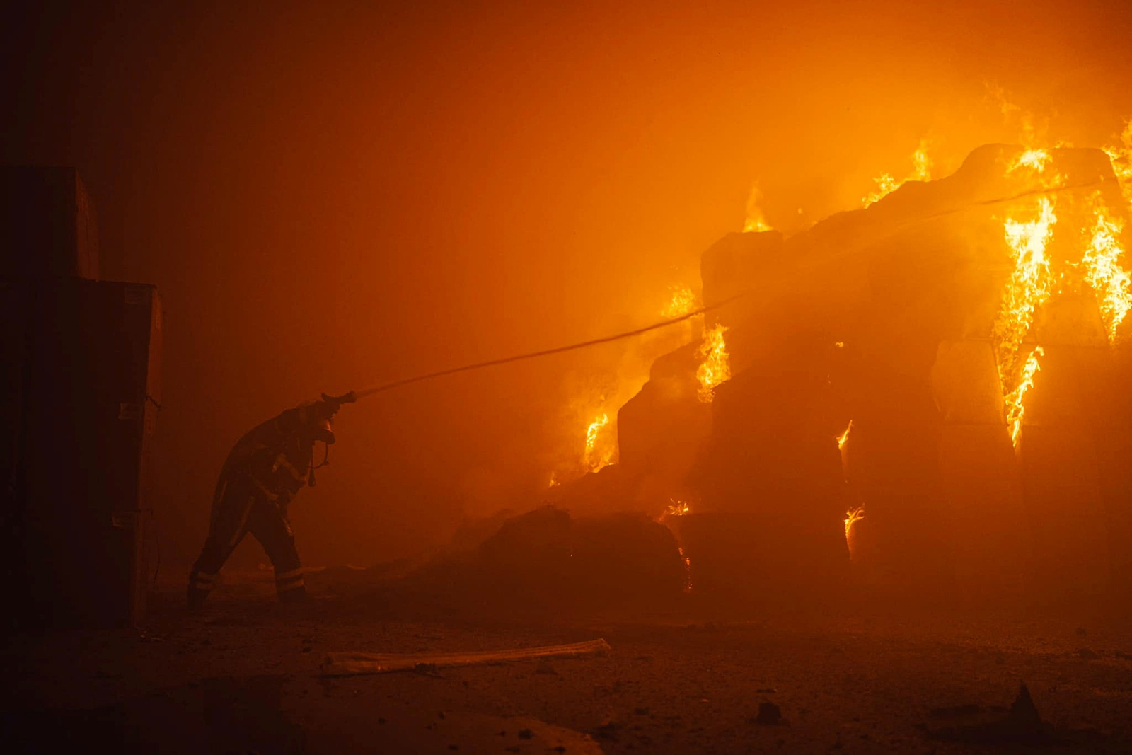 A firefighter works at a site of a tobacco factory damaged during Russian drone strike in Kyiv, Ukraine on May 28.