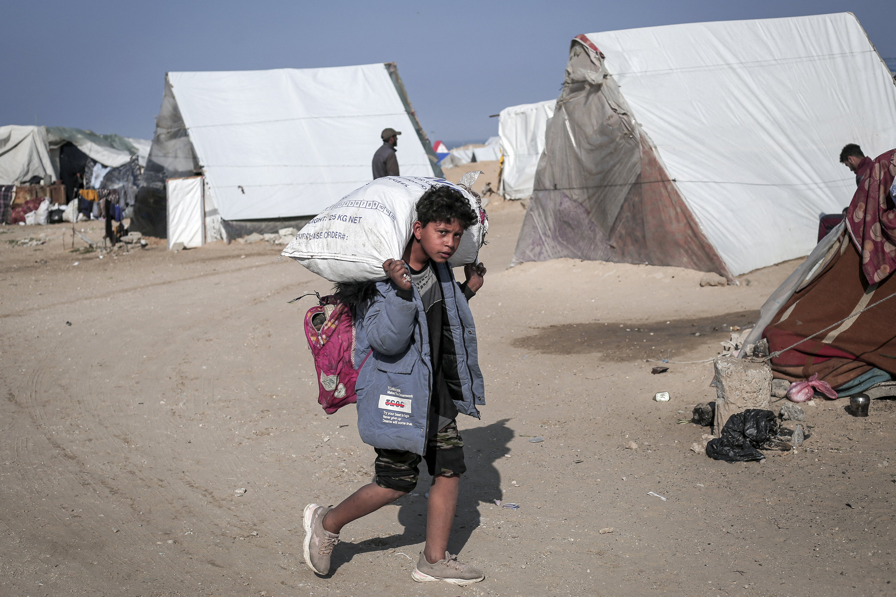 A child carries a sack filled with personal belongings at a camp for displaced Palestinians, in Rafah, Gaza, on February 28.