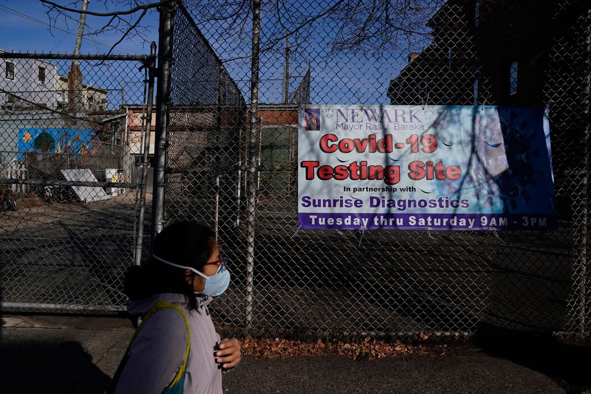 A woman walks past a coronavirus testing site in the Ironbound section of Newark, New Jersey on November 24.