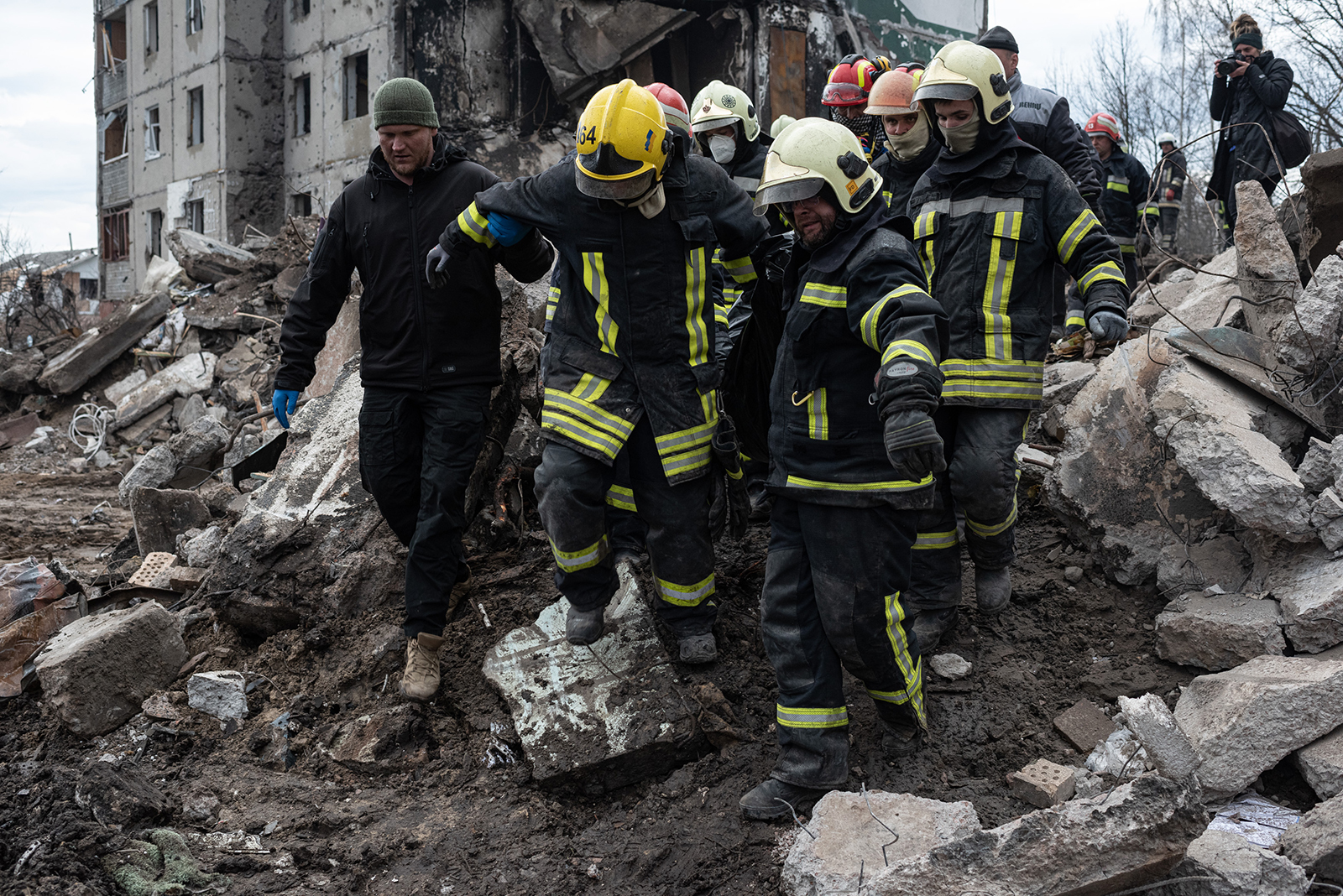 Rescue workers carry a body found among the rubble of a destroyed apartment building on April 9 in Borodianka, Ukraine.