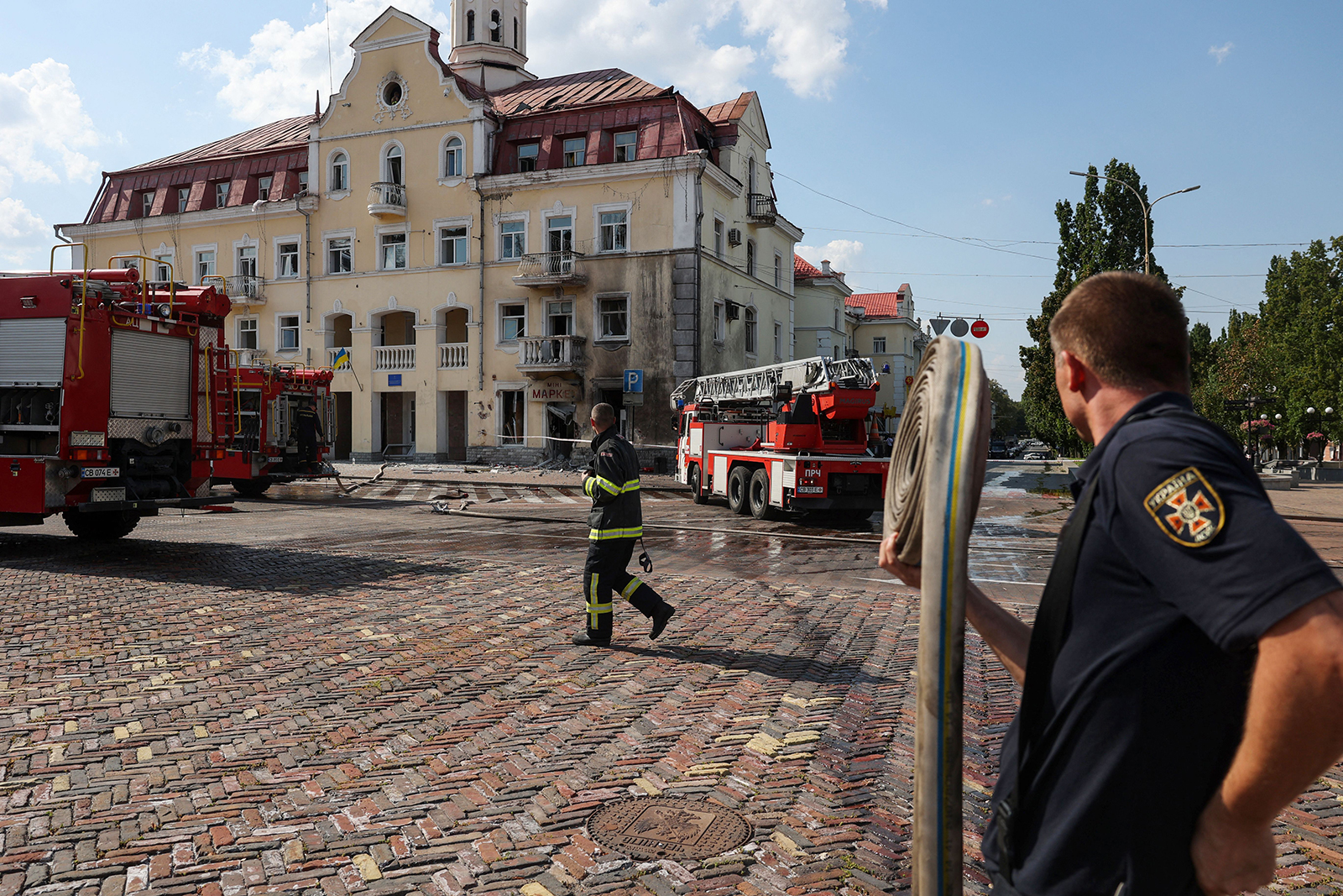 Ukrainian firefighters work at the site of a Russian missile strike in Chernihiv, Ukraine, on August 19. 