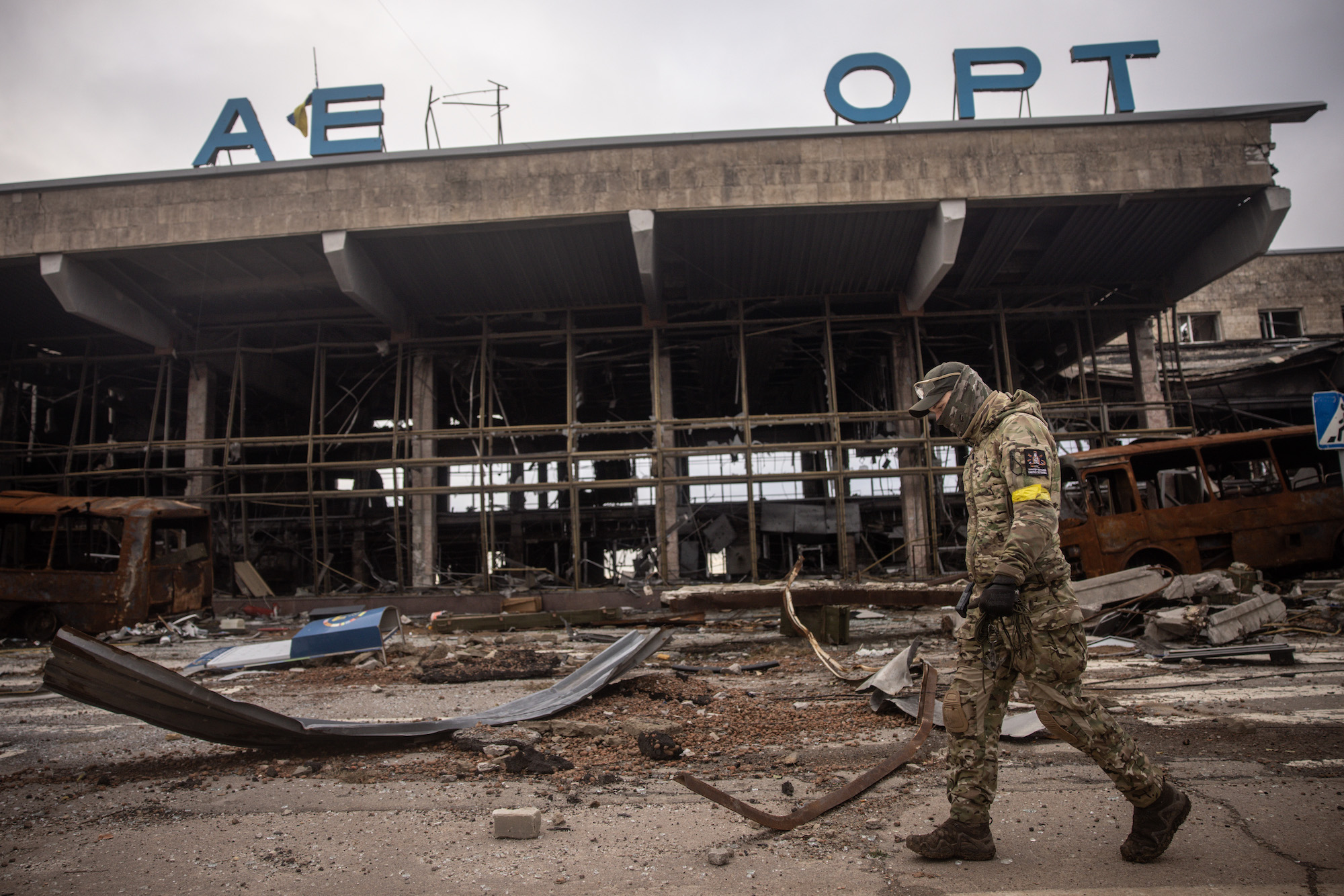A member of the Ukrainian military searches destroyed sections of the Kherson International Airport on Friday. 
