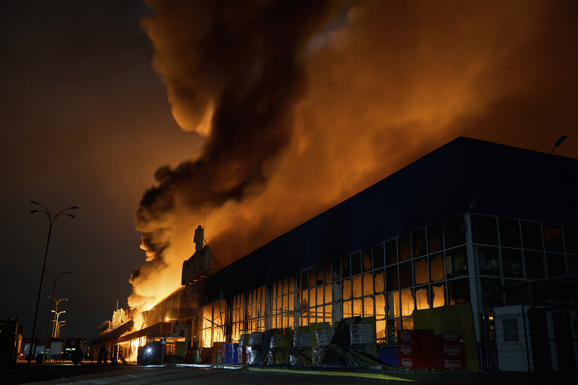Ukrainian State Emergency Service firefighters attend to a fire at a shopping center in Kherson, Ukraine, on February 3.