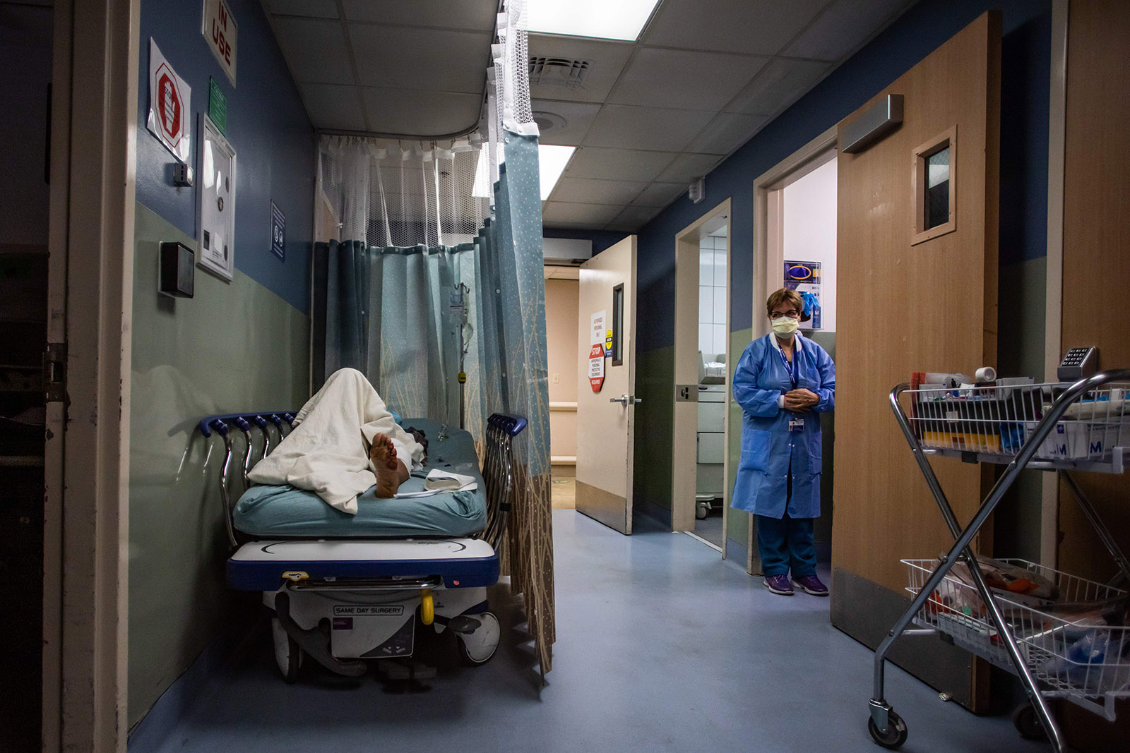 A patient rests in a corridor waiting for a room at Providence Cedars-Sinai Tarzana Medical Center in Tarzana, California on January 3.
