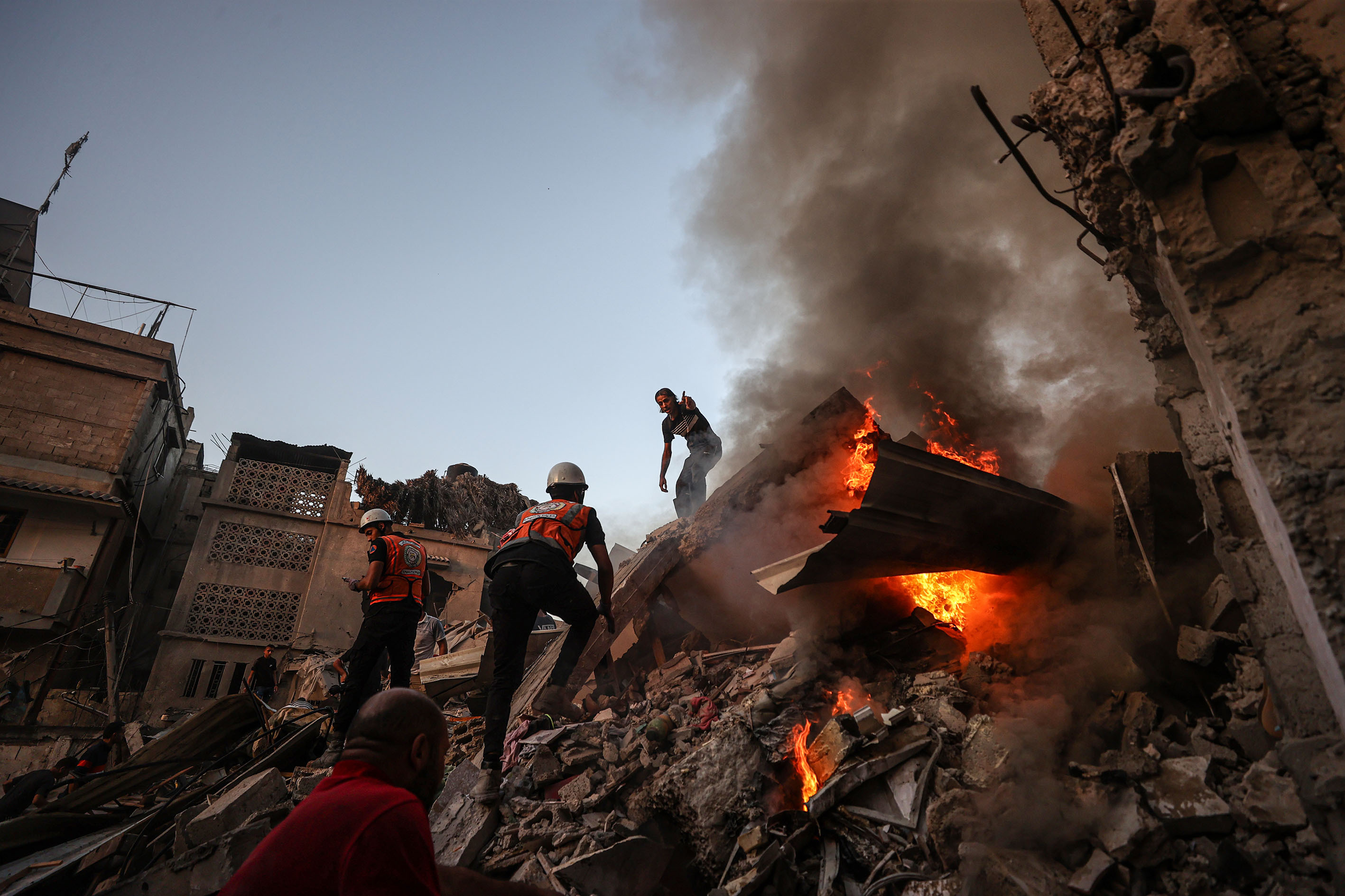 Teams put out a fire that broke out among the rubble of destroyed building during search and rescue operations after an Israeli attack in Khan Younis, Gaza, on November 4.