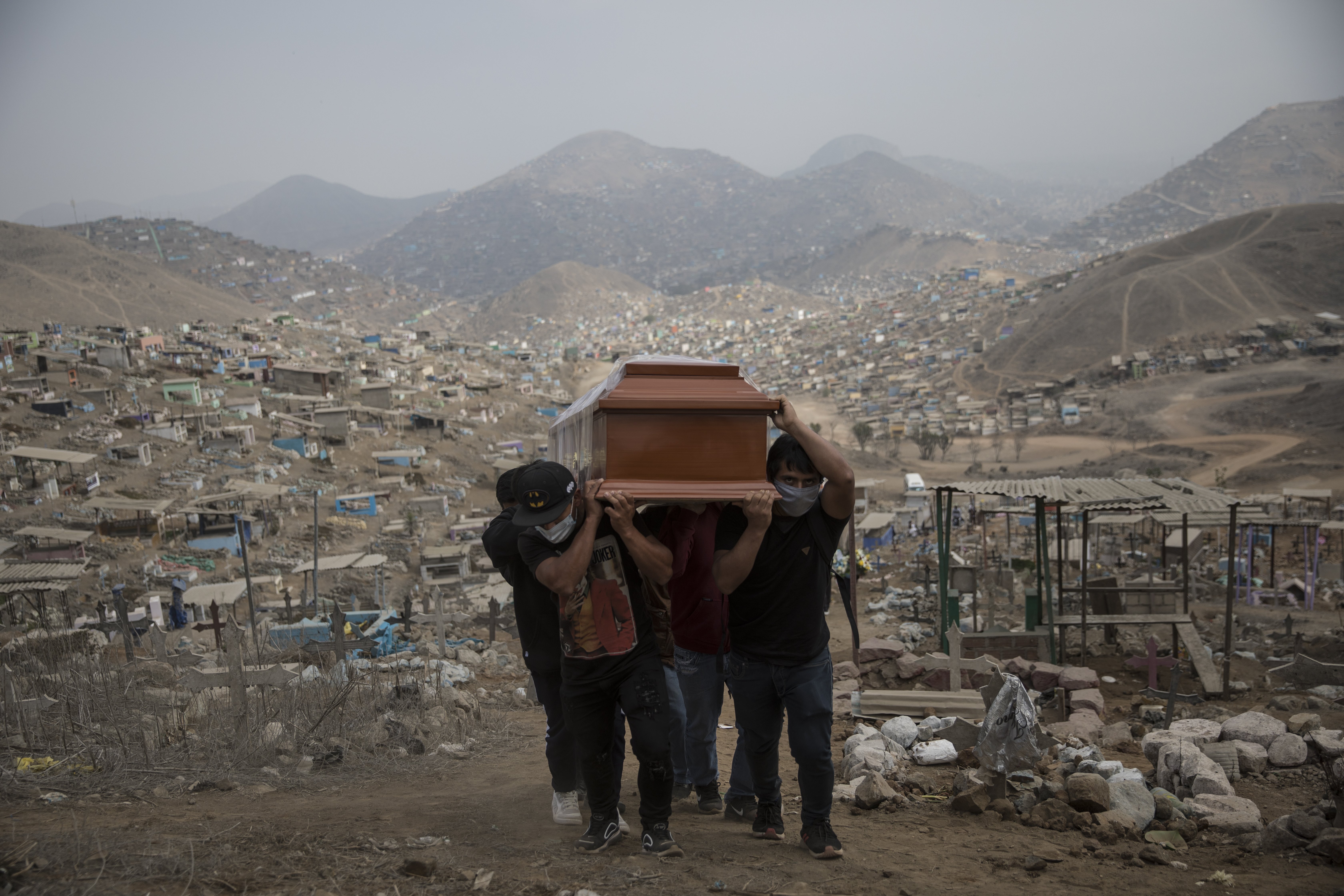 Relatives carry the coffin of a suspected Covid-19 victim at the Nueva Esperanza cemetery on the outskirts of Lima, Peru, on May 28.