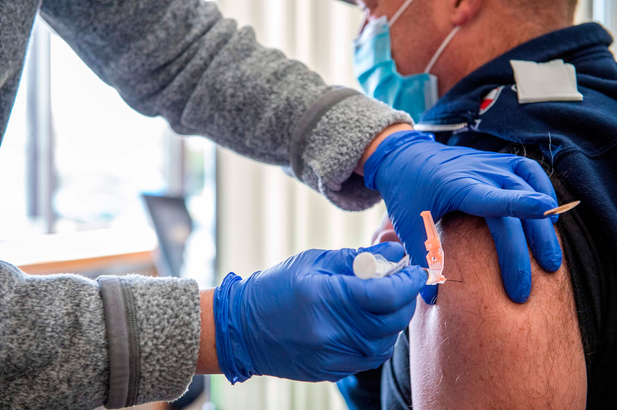 Nurse Patti Ward inoculates a fire fighter with the Moderna Covid-19 vaccine at UMass Memorial Hospital in Marlborough, Massachusetts on January 12.