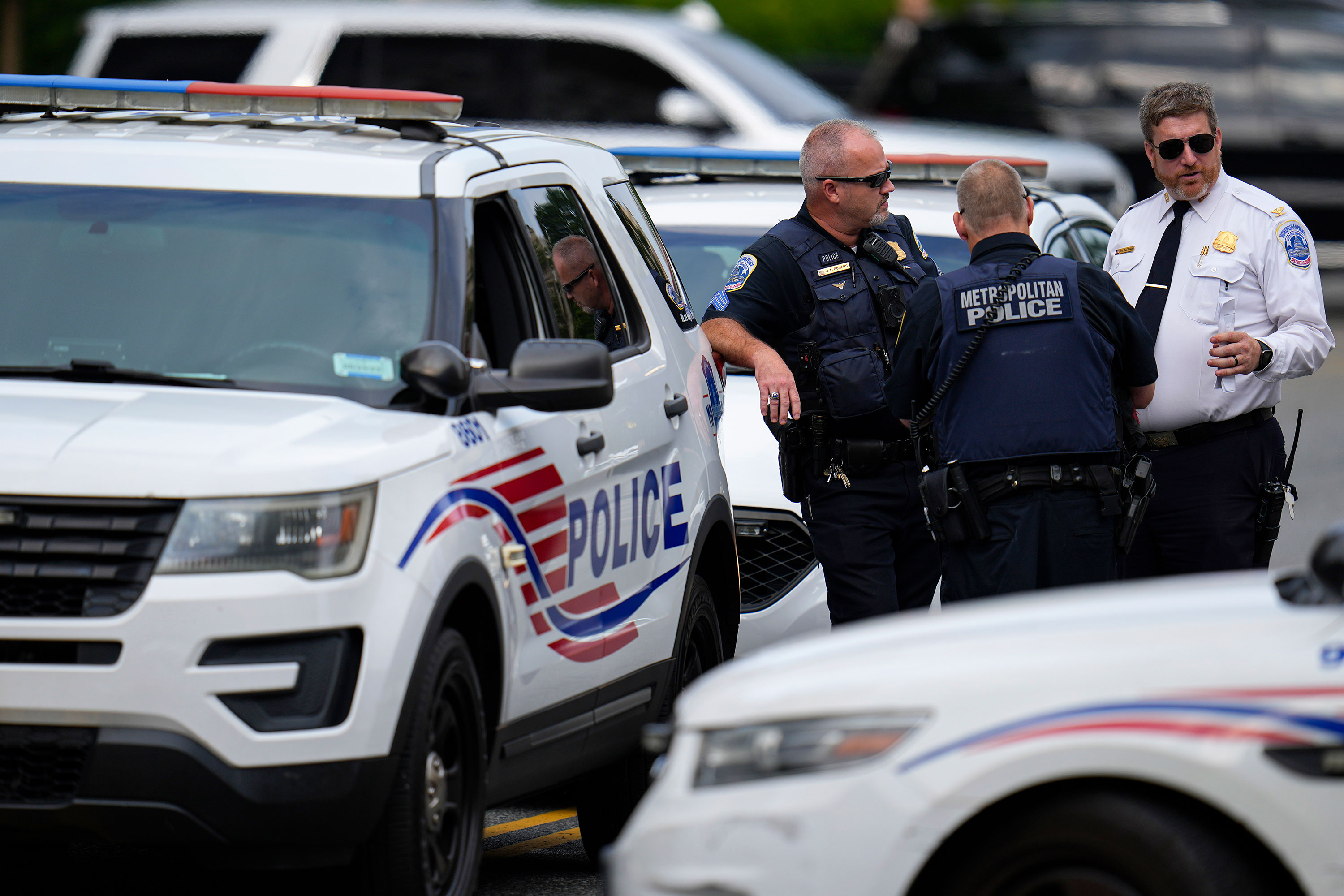 Washington Metropolitan Police talk as they patrol the area outside the E. Barrett Prettyman US Federal Courthouse on Thursday.