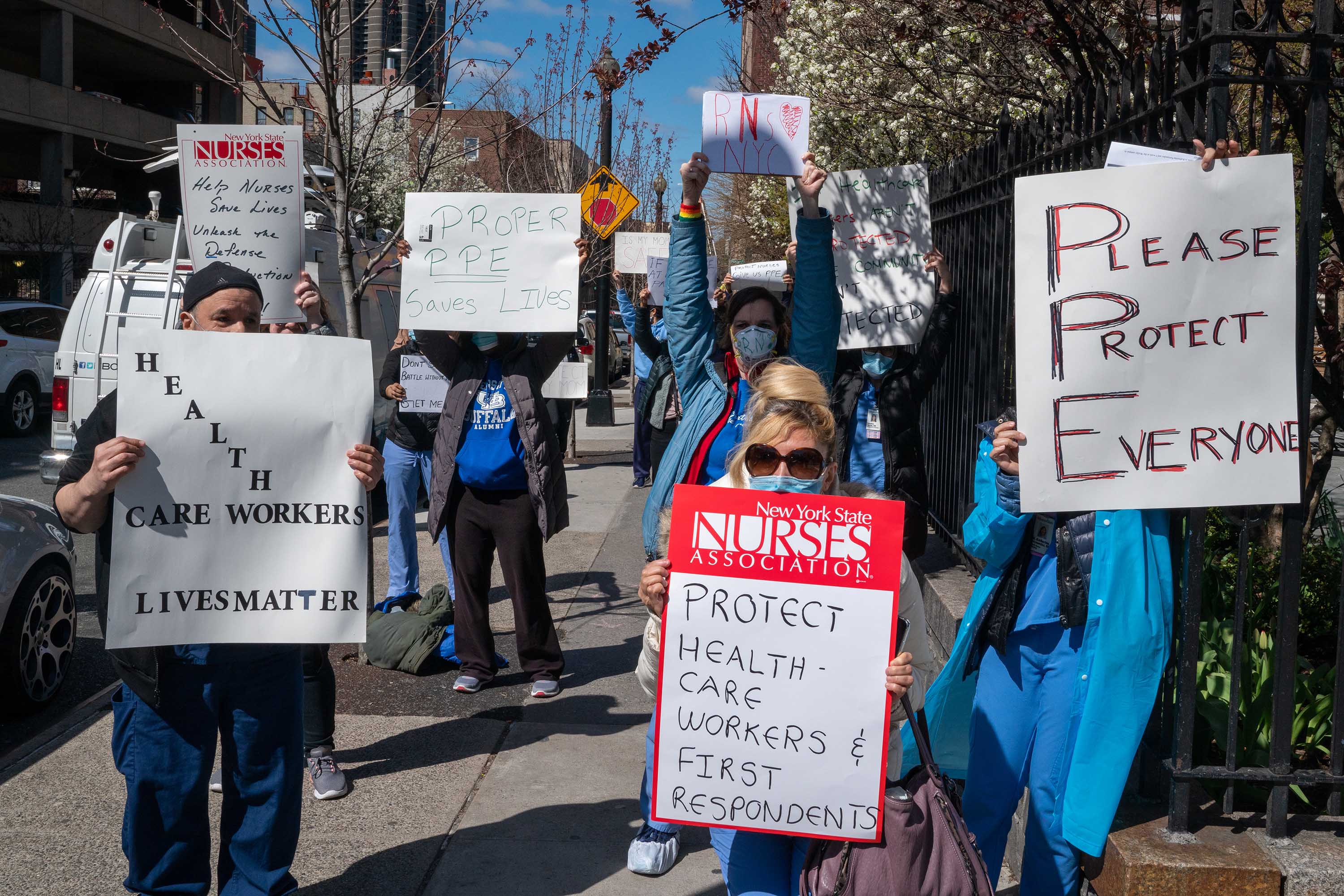 Medical personnel hold signs during a demonstration for increased personal protection equipment outside Montefiore Hospital in the Bronx, New York, on April 2.