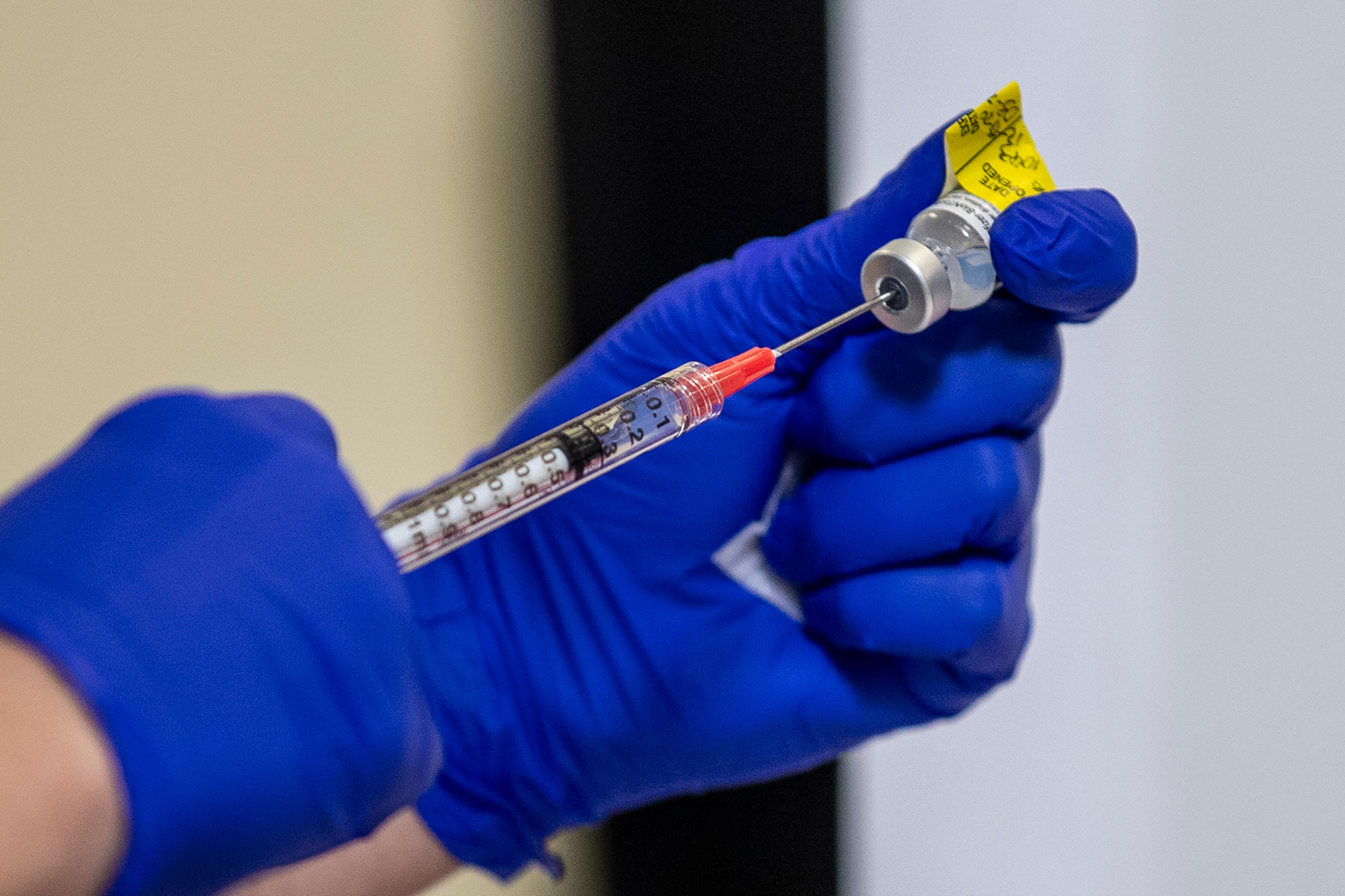 The Pfizer-BioNTech Covid-19 vaccine is prepared prior to a vaccine event at Kaiser Permanente Capitol Hill Medical Center on December 17 in Washington, DC.