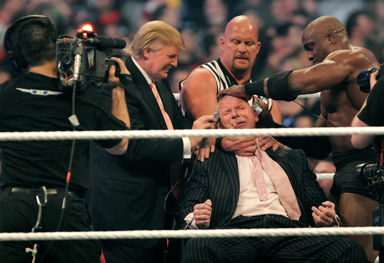 WWE chairman Vince McMahon (center) has his head shaved by Donald Trump and Bobby Lashley (right) while being held down by ''Stone Cold'' Steve Austin after losing a bet in the Battle of the Billionaires at the 2007 World Wrestling Entertainment's Wrestlemania at Ford Field in Detroit, Michigan, on April 1, 2007. 