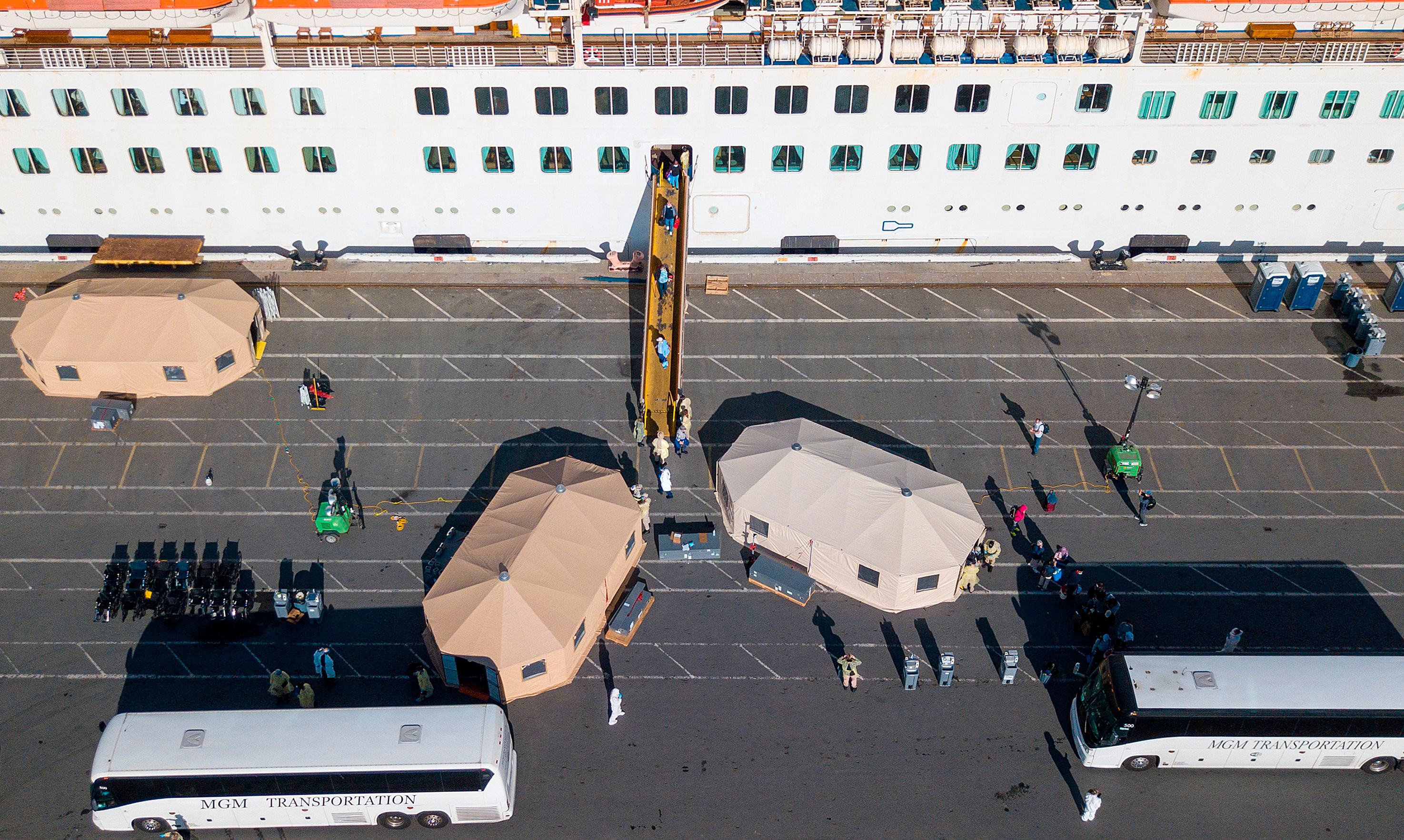 Passengers are disembarked from the Grand Princess cruise ship at the Port of Oakland in Oakland, California on March 10, 2020. 