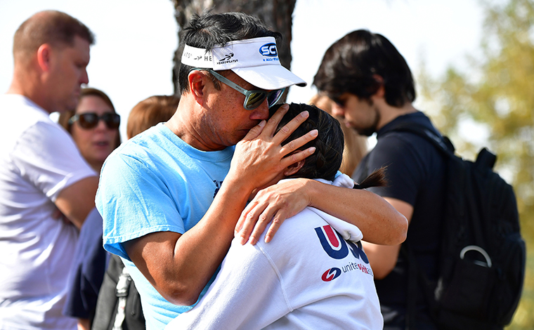 Grieving students from Saugus High School reunite with their parents at Central Park in Santa Clarita.