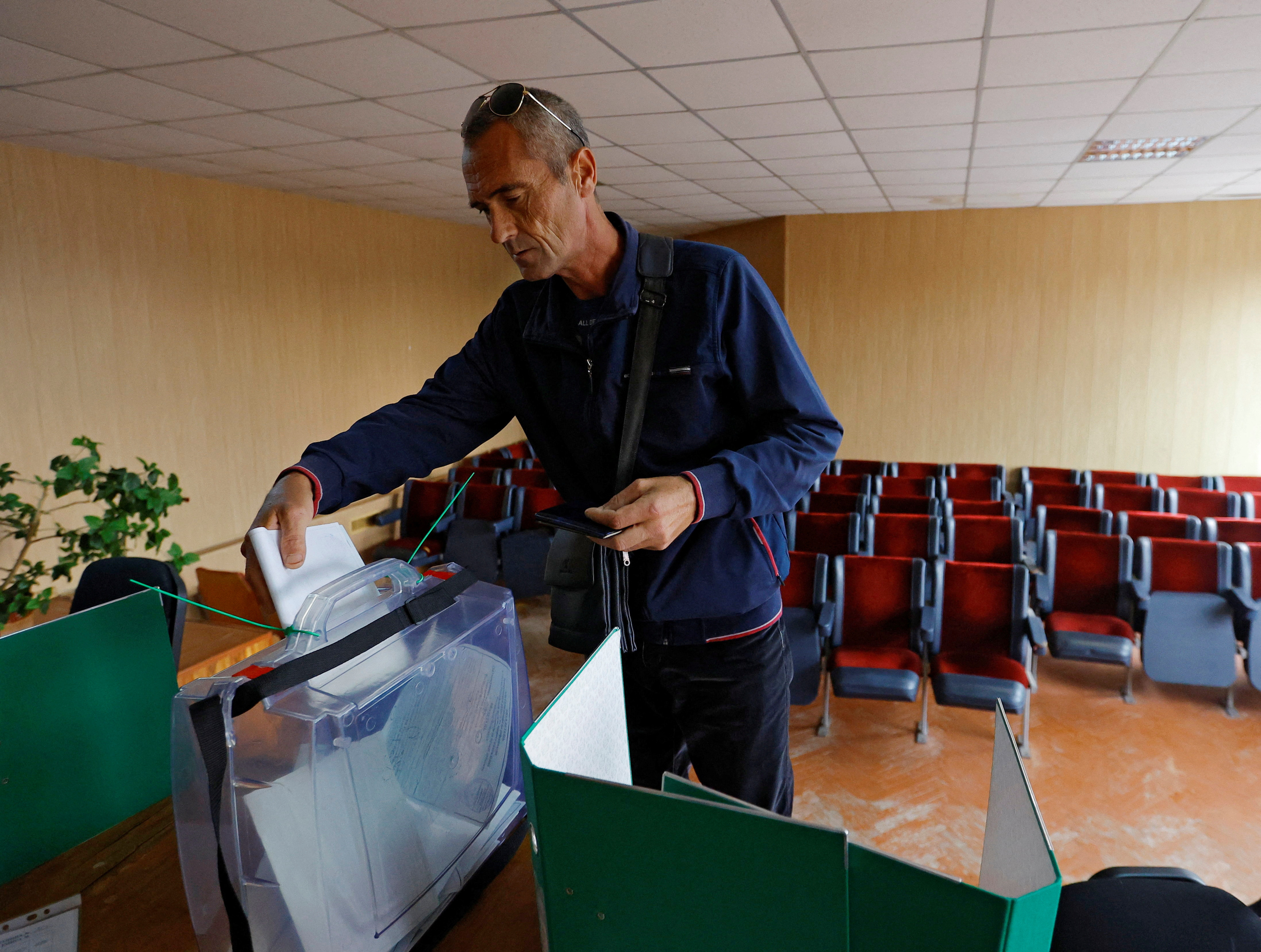 A man casts his ballot during a referendum on the secession of Zaporizhzhia region from Ukraine in the Russian-controlled city of Melitopol on September 26.
