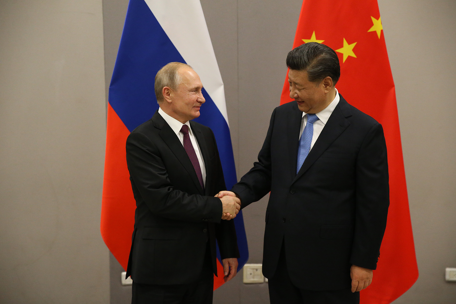 Vladimir Putin greets Chinese leader Xi Jinping during their bilateral meeting in Brasilia, Brazil on November 13, 2019.
