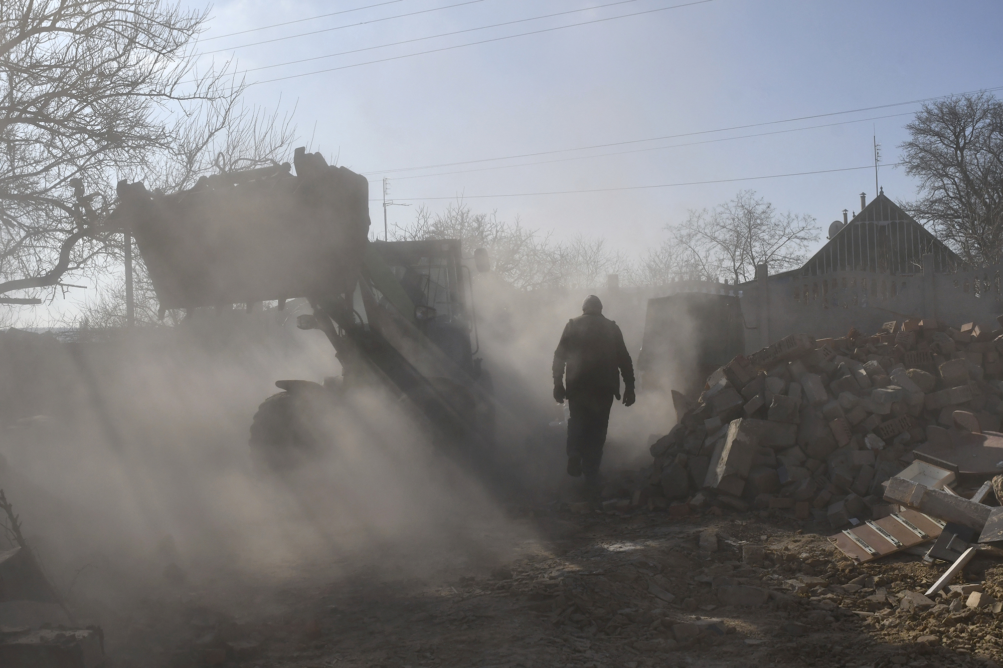 Local residents clear the rubble of a private house following a Russian rocket attack in Komyshevakha in the Zaporizhzhia region, Ukraine, on February 10.