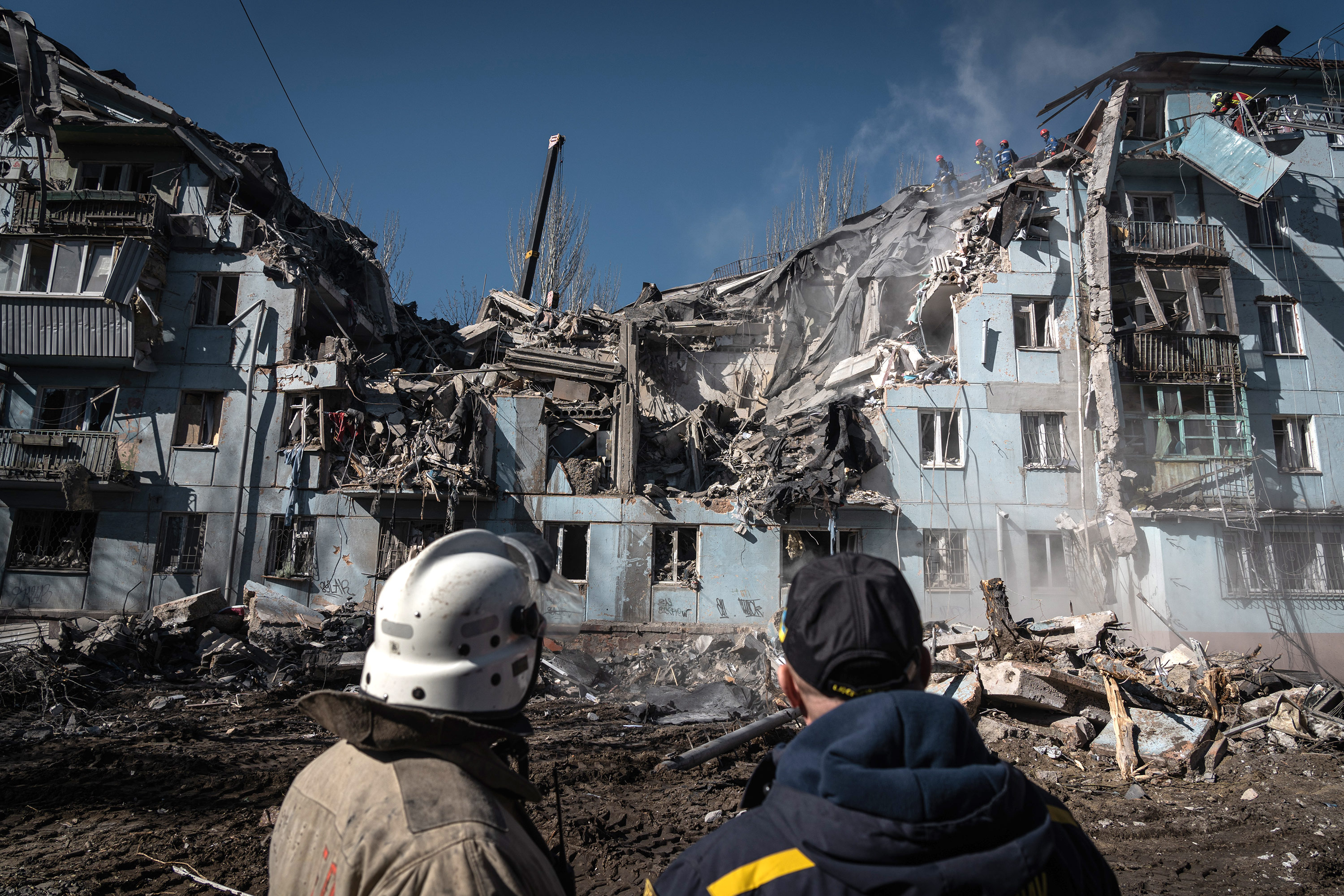 Rescue workers search a damaged building after a missile strike in Zaporizhzhia, Ukraine, on March 2. 