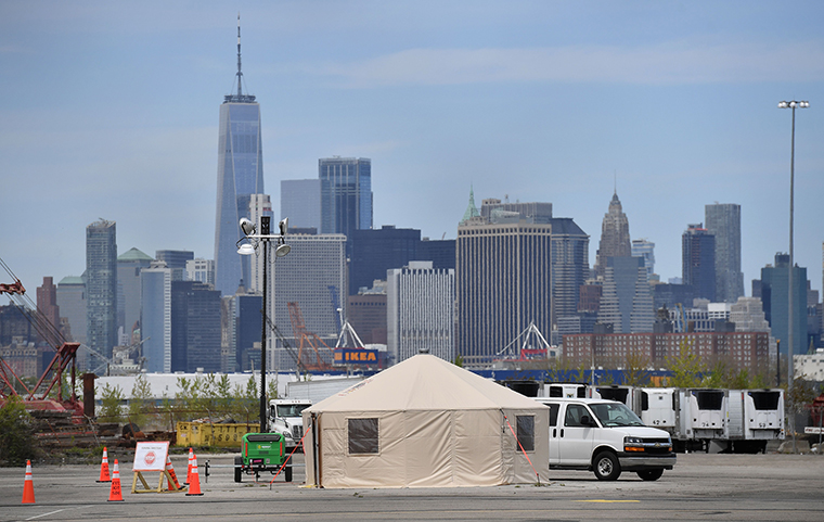 An F.D.N.Y. tent and refrigerated trucks serving as make shift morgues are seen on Tuesday, May 5, in the Brooklyn borough of New York City. 