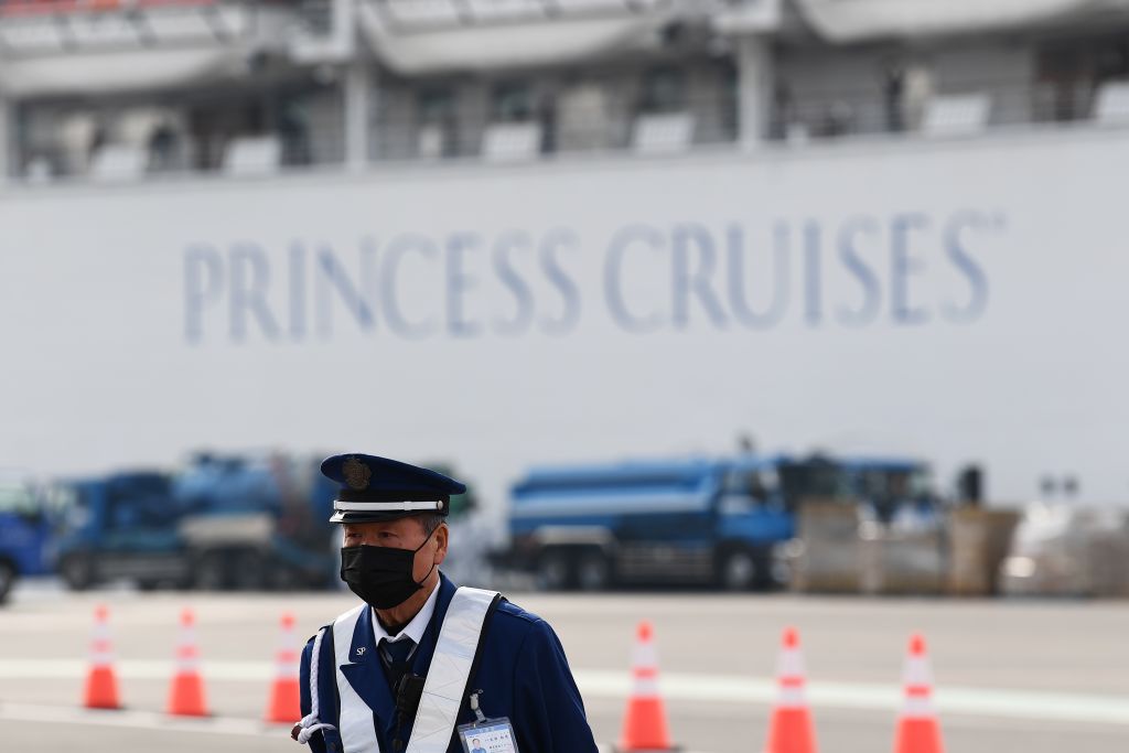 Passengers are seen on balconies of the Diamond Princess cruise ship at the Daikoku Pier Cruise Terminal in Yokohama port on February 14.