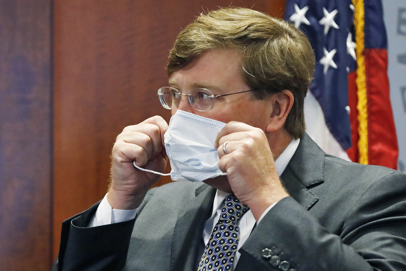 Gov. Tate Reeves adjusts his face mask as he prepares to leave his Covid-19 press briefing on Wednesday, August 5, in Jackson, Mississippi.